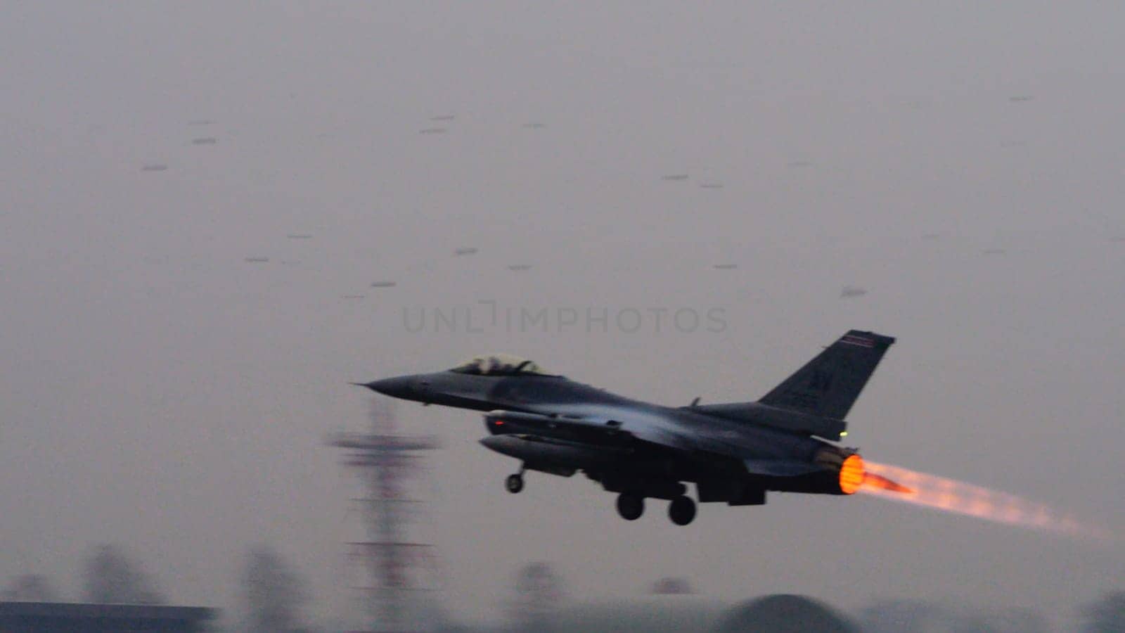 US combat aircraft takes off, its afterburner flame stark against the backdrop, ready to safeguard NATO airspace from any threat including terrorist. Copy Space