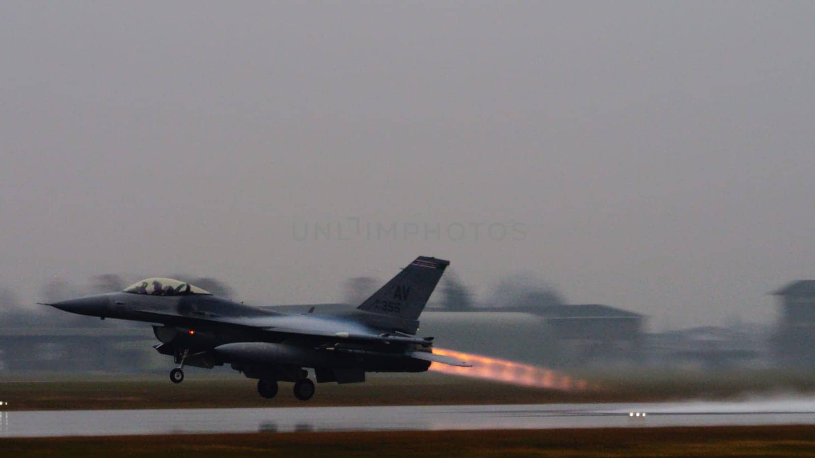 US combat aircraft takes off, its afterburner flame stark against the backdrop, ready to safeguard NATO airspace from any threat including terrorist. Copy Space