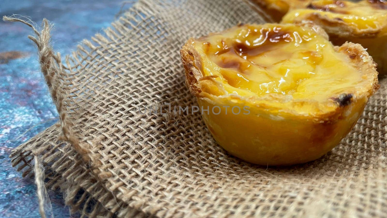 Lots of freshly baked desserts Pastel de nata or Portuguese egg tart. Pastel de Belm is a small pie with a crispy puff pastry crust and a custard cream filling. A small dessert, a cupcake. by Roshchyn