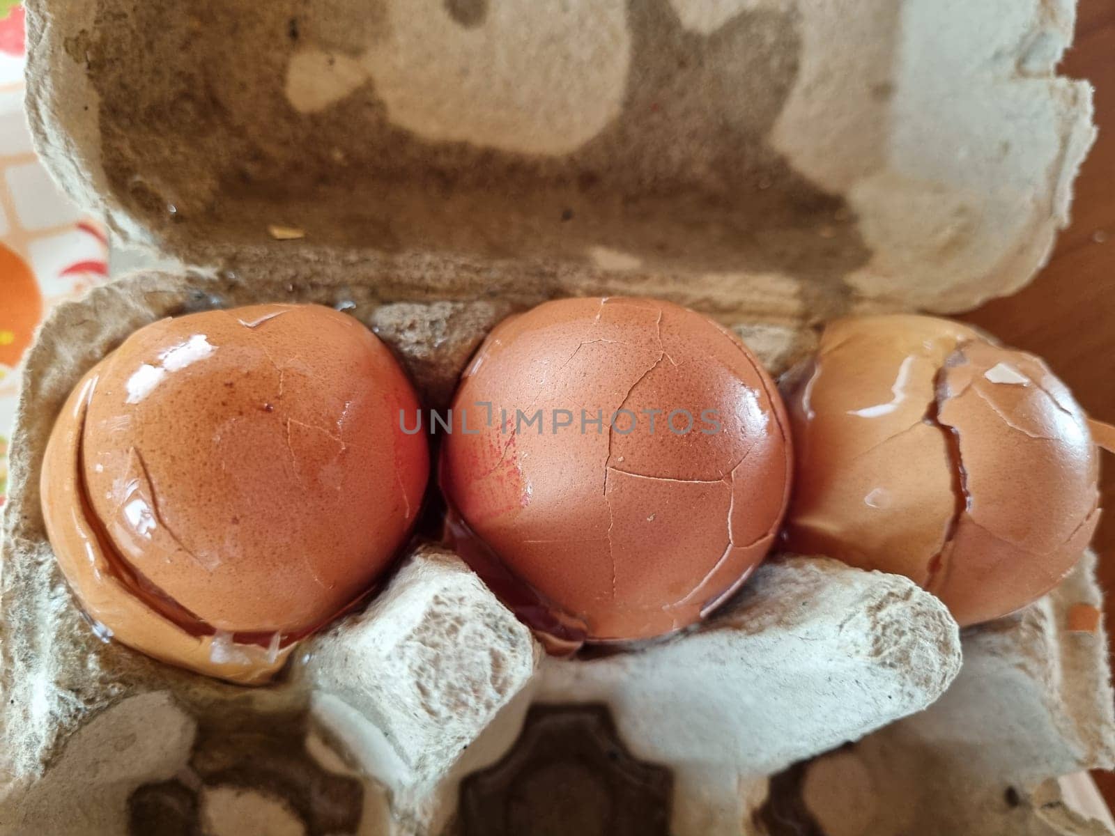 Three eggs in box on table food concept
