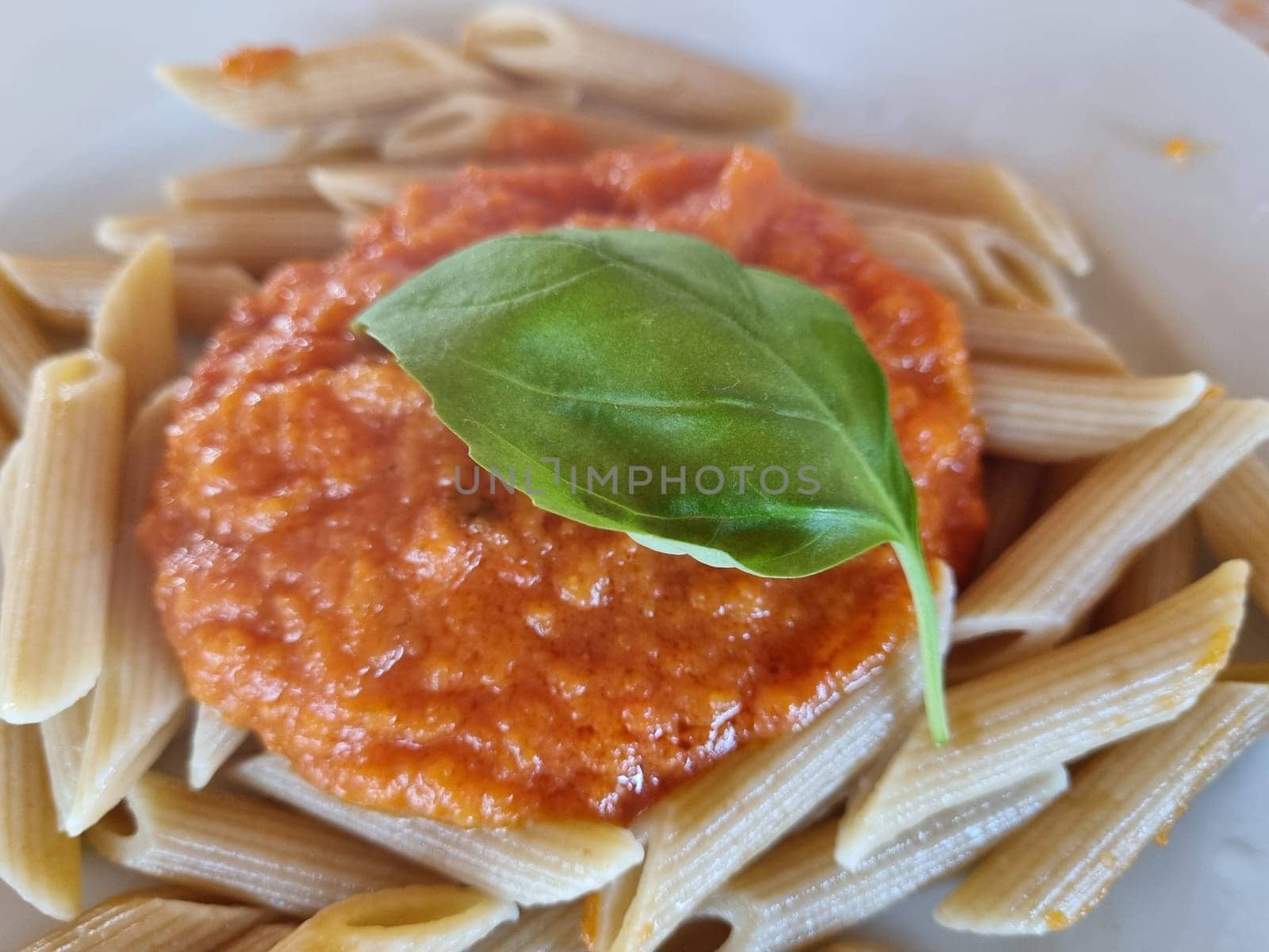 Delicious Italian pasta with tomato sauce and basil