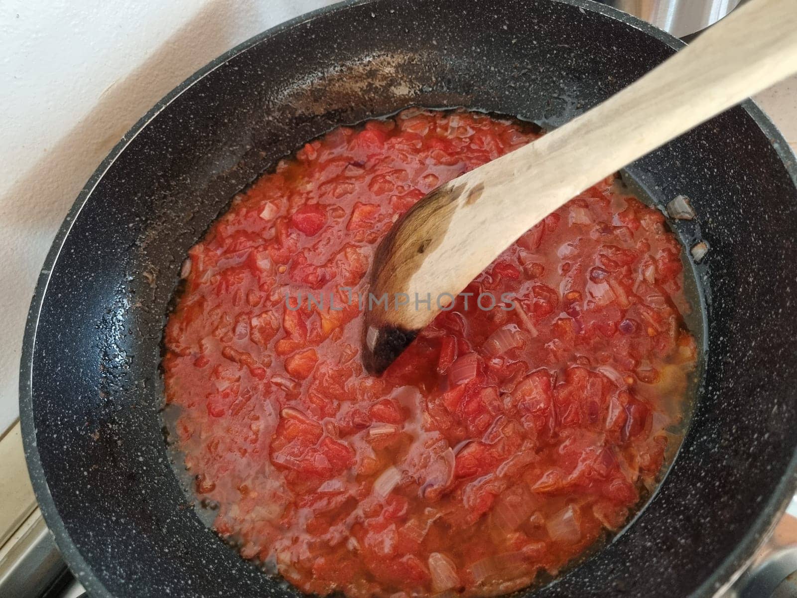 Cooking ingredients recipe and cookware on wooden spoon. Tomato sausage typical italian food for Pasta topping.