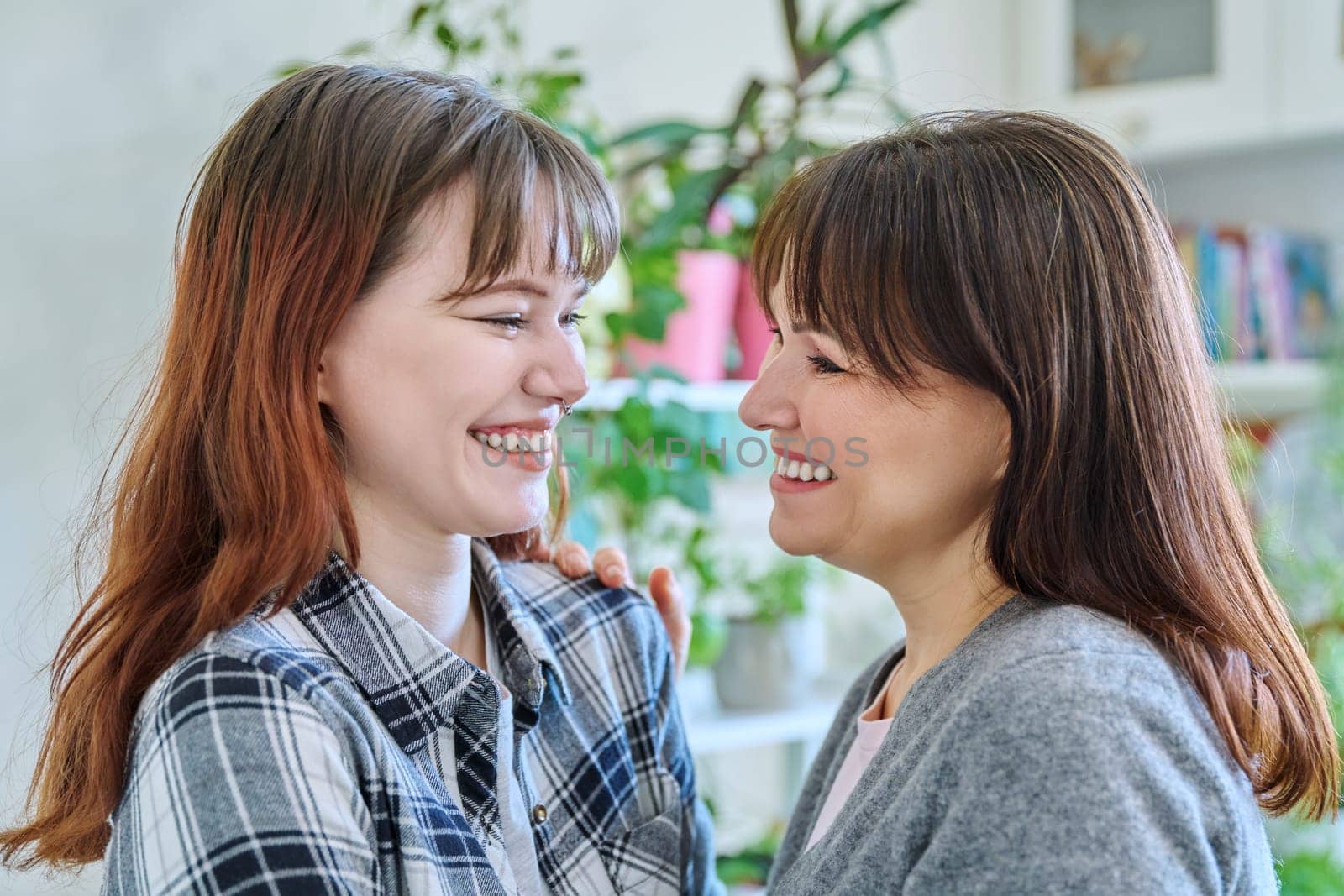 Close-up profile portrait of mother and daughter 18-20 years old. by VH-studio