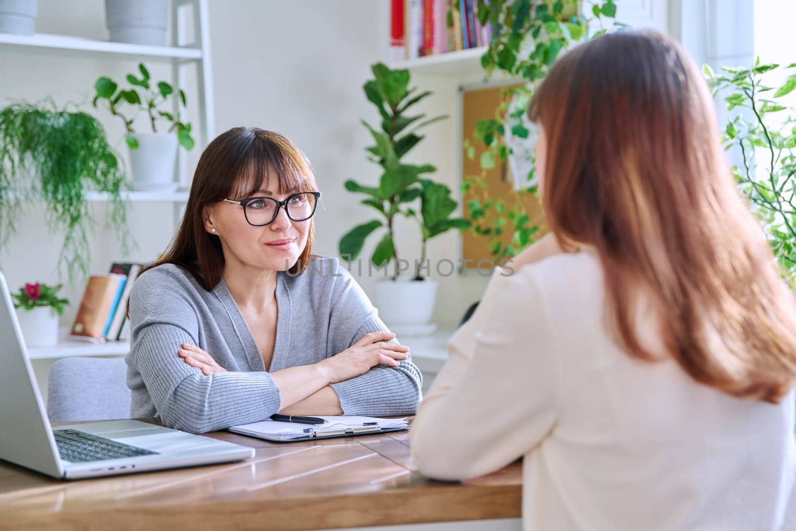 Young female college student at meeting with professional mental therapist by VH-studio