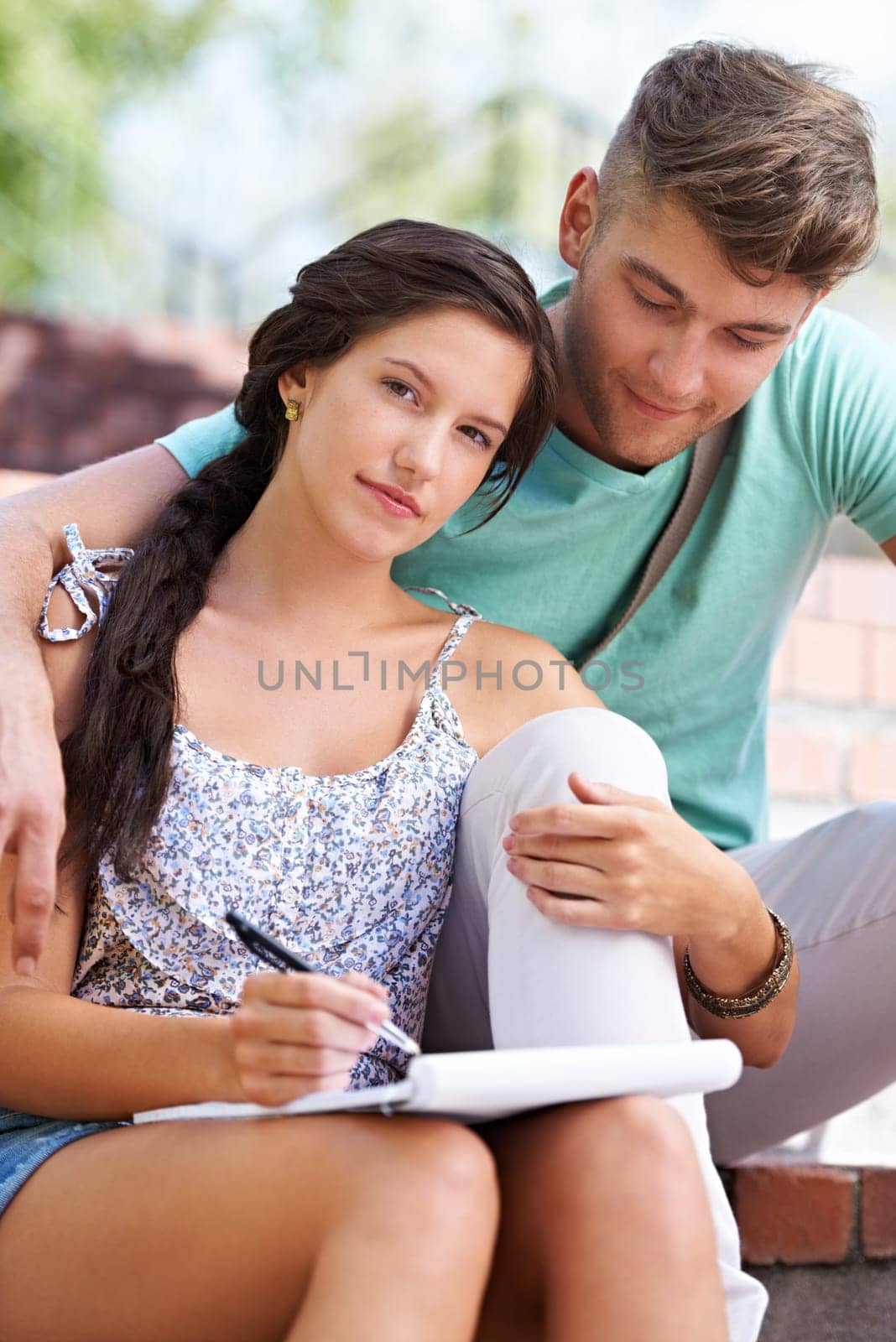 Students, couple and book with woman on stairs with smile, hug and portrait with notes at university. People, studying and scholarship for knowledge, education and notebook with embrace at college by YuriArcurs