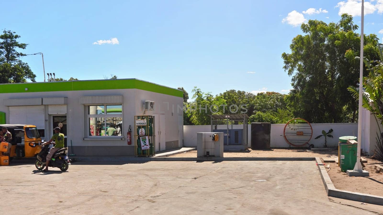 Sakaraha, Madagascar - May 05, 2019: Typical gas station (green Galana brand) at Madagascar on sunny day. Cars/fuel is expensive for locals, stations are used mostly for large trucks / small scooters