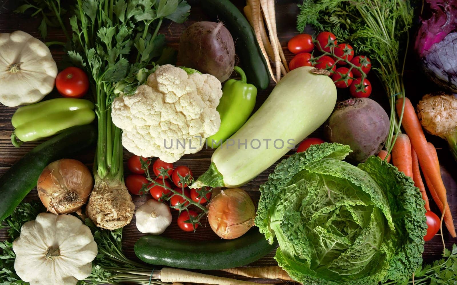 Top down view, group of various vegetables on dark wood board. Healthy vegetable concept