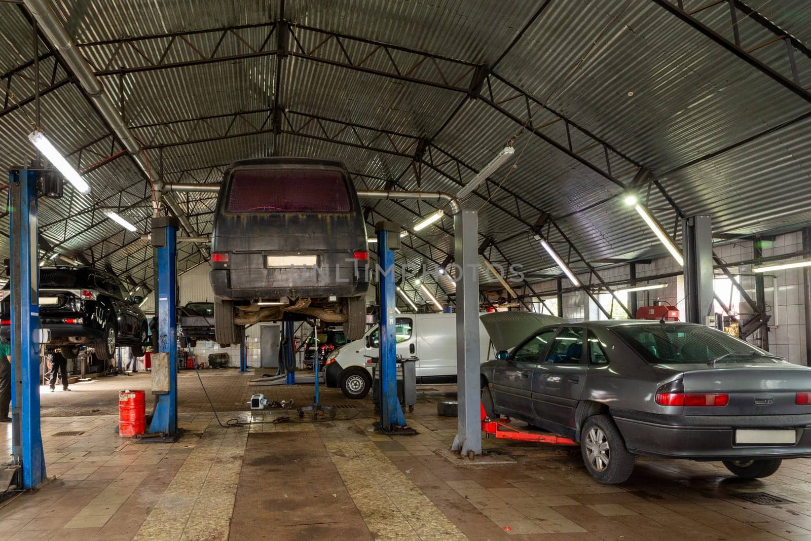 Cars in automobile repair service center. by BY-_-BY