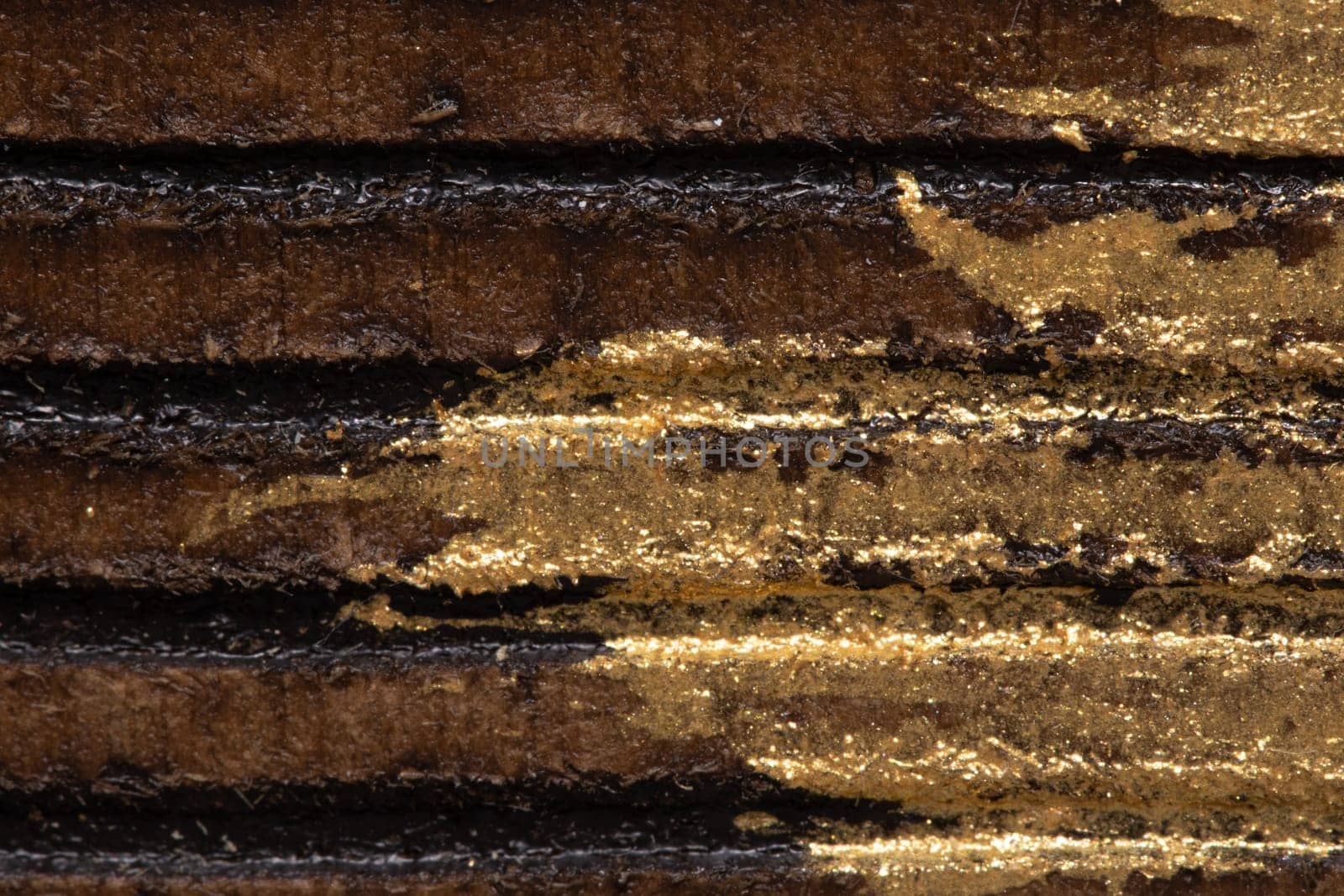 This image features a close-up shot of a textured surface with alternating golden and black stripes, showcasing intricate detail and a metallic sheen.