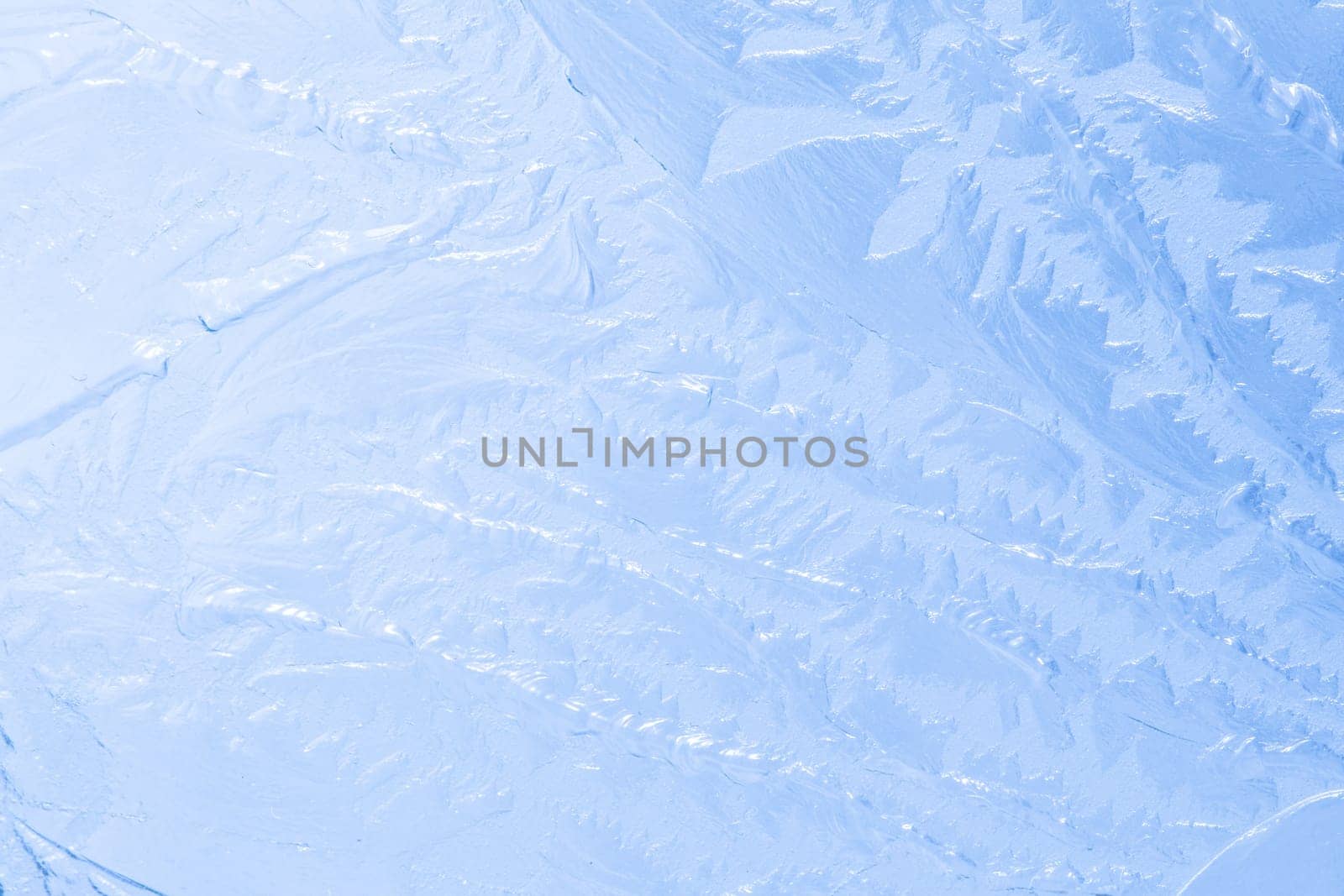 Light blue frosty pattern on glass, abstract background for Christmas decorations. Imitation of frozen glass.