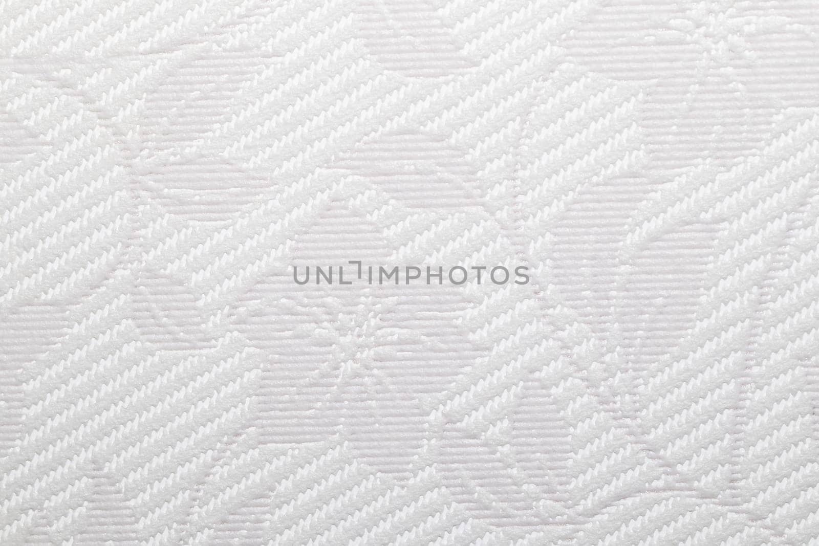 This image features a detailed close-up of a light gray textured vinyl wallpapers showcasing a intricate diagonal weave pattern with floral elements.