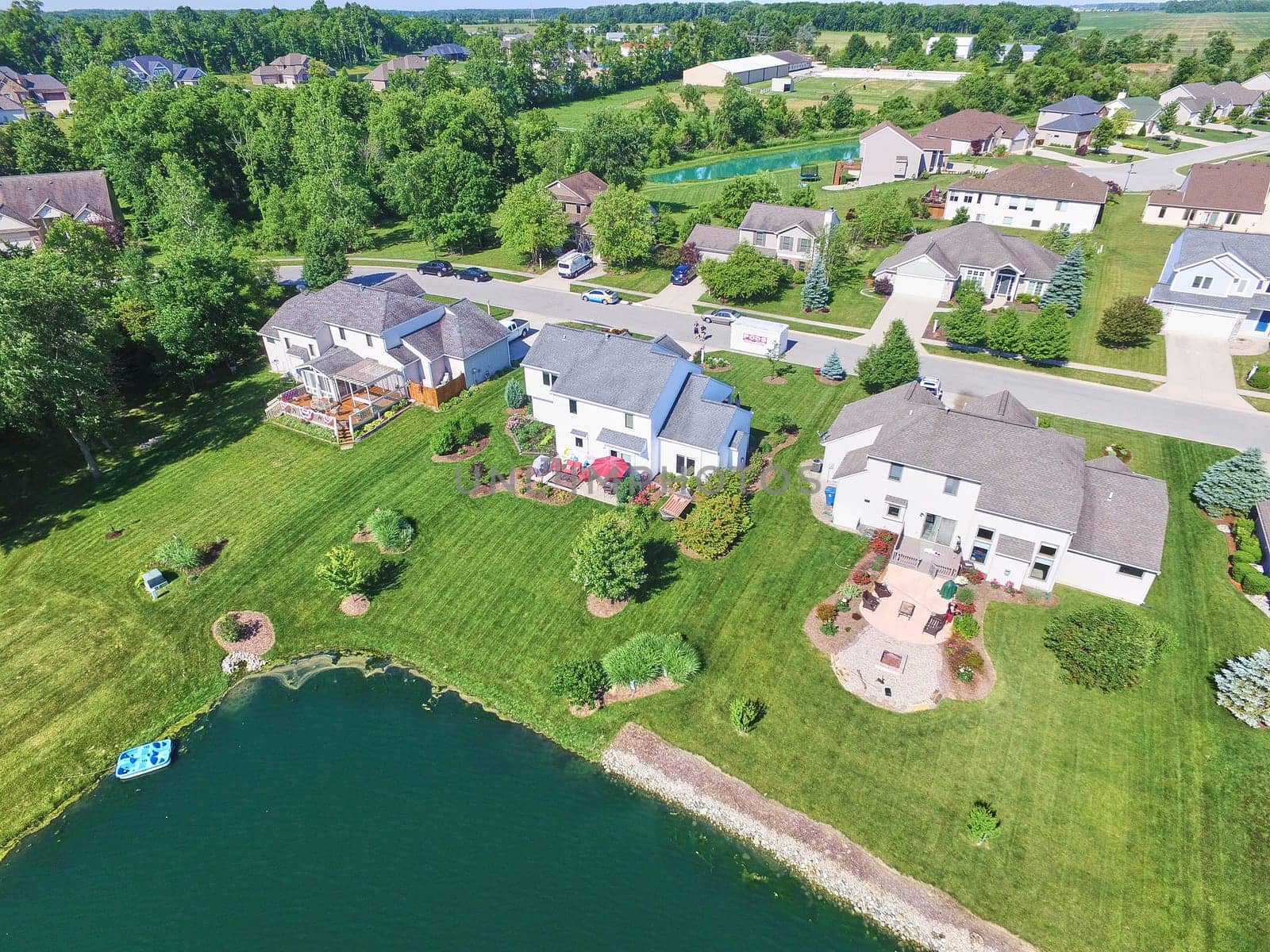 Aerial Summer View of Serene Suburban Lakeside Community in Fort Wayne, Indiana, 2016 - Picture Perfect Homes with Manicured Lawns and a Personal Dock