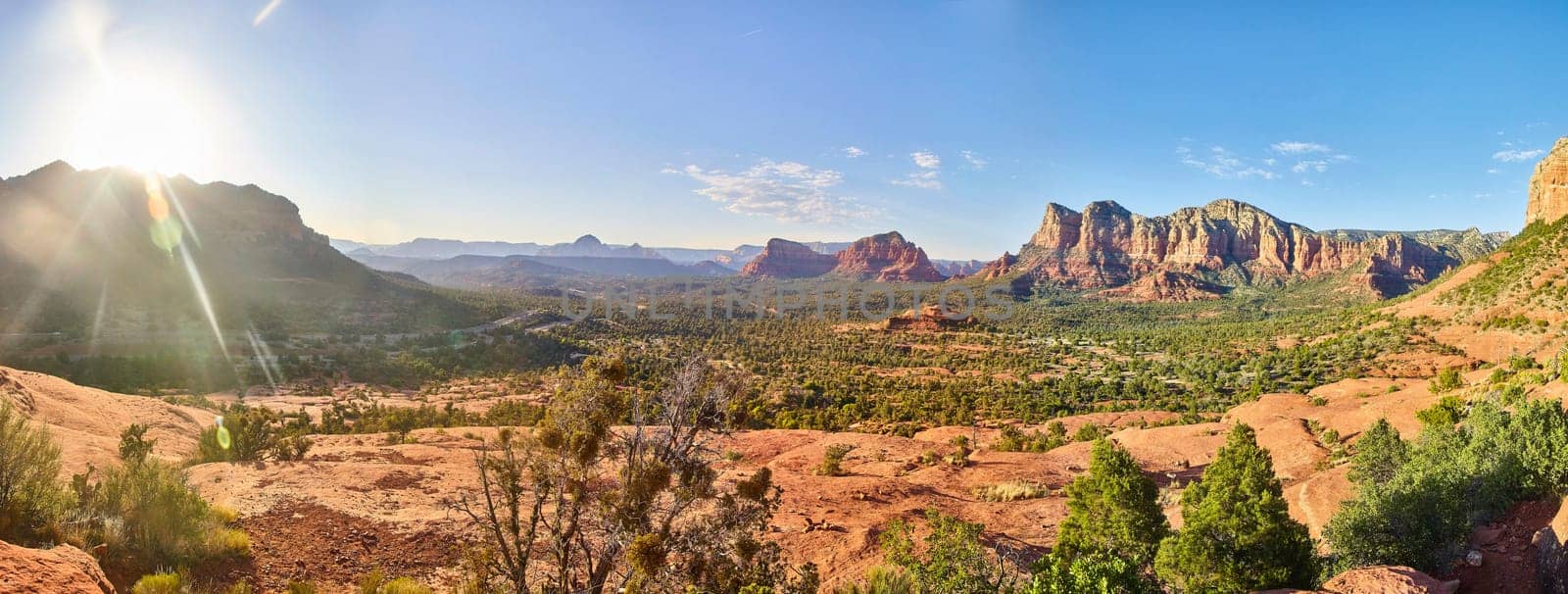 Breathtaking panoramic view of Arizona's majestic red rock formations in Sedona, bathed in the warm glow of the sun, showcasing desert beauty and the allure of adventure travel, 2016.