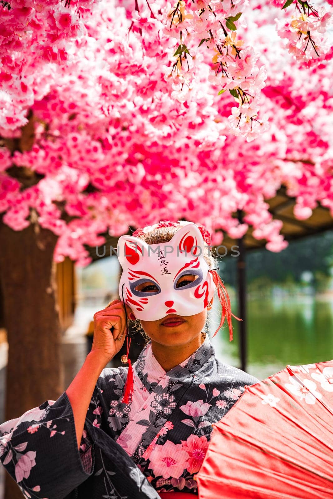 Asian girl in kimono and umbrella in Japanese theme park Hinoki Land in Chai Prakan District, Chiang Mai