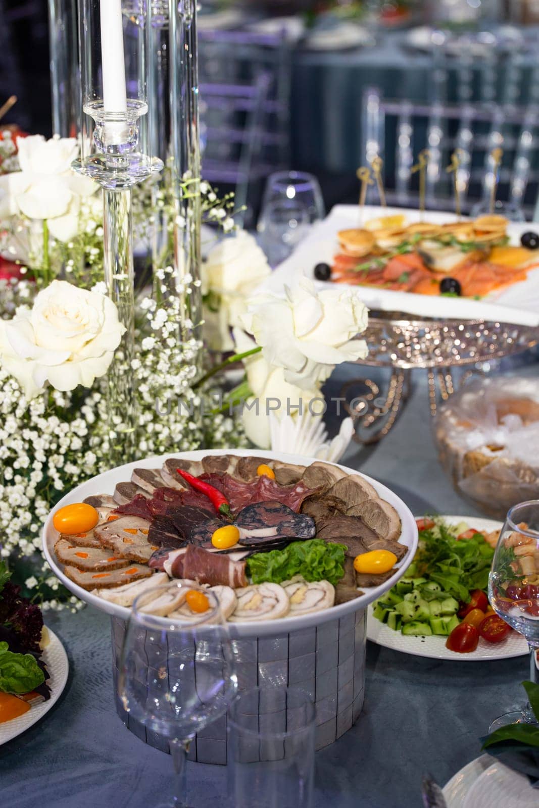 Elegant Cheese and Cold Cuts Platter with Garnishes on Decorated Table by Pukhovskiy