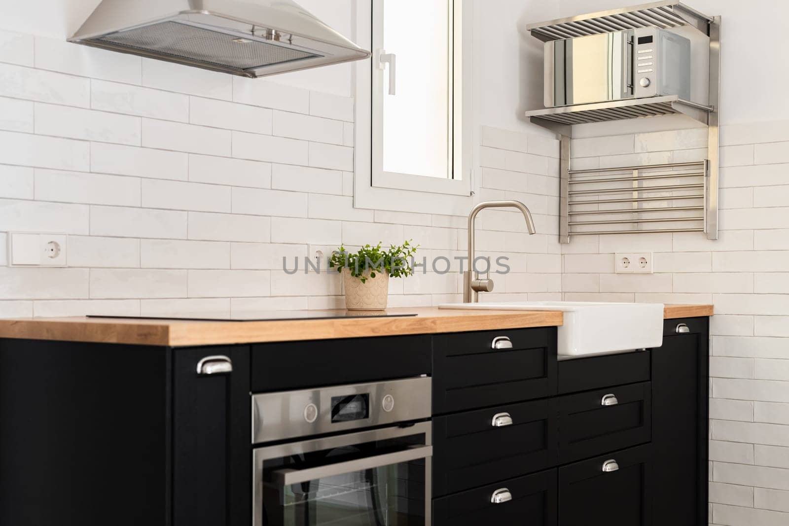 Kitchen unit with oven, sink and appliances in apartment by apavlin