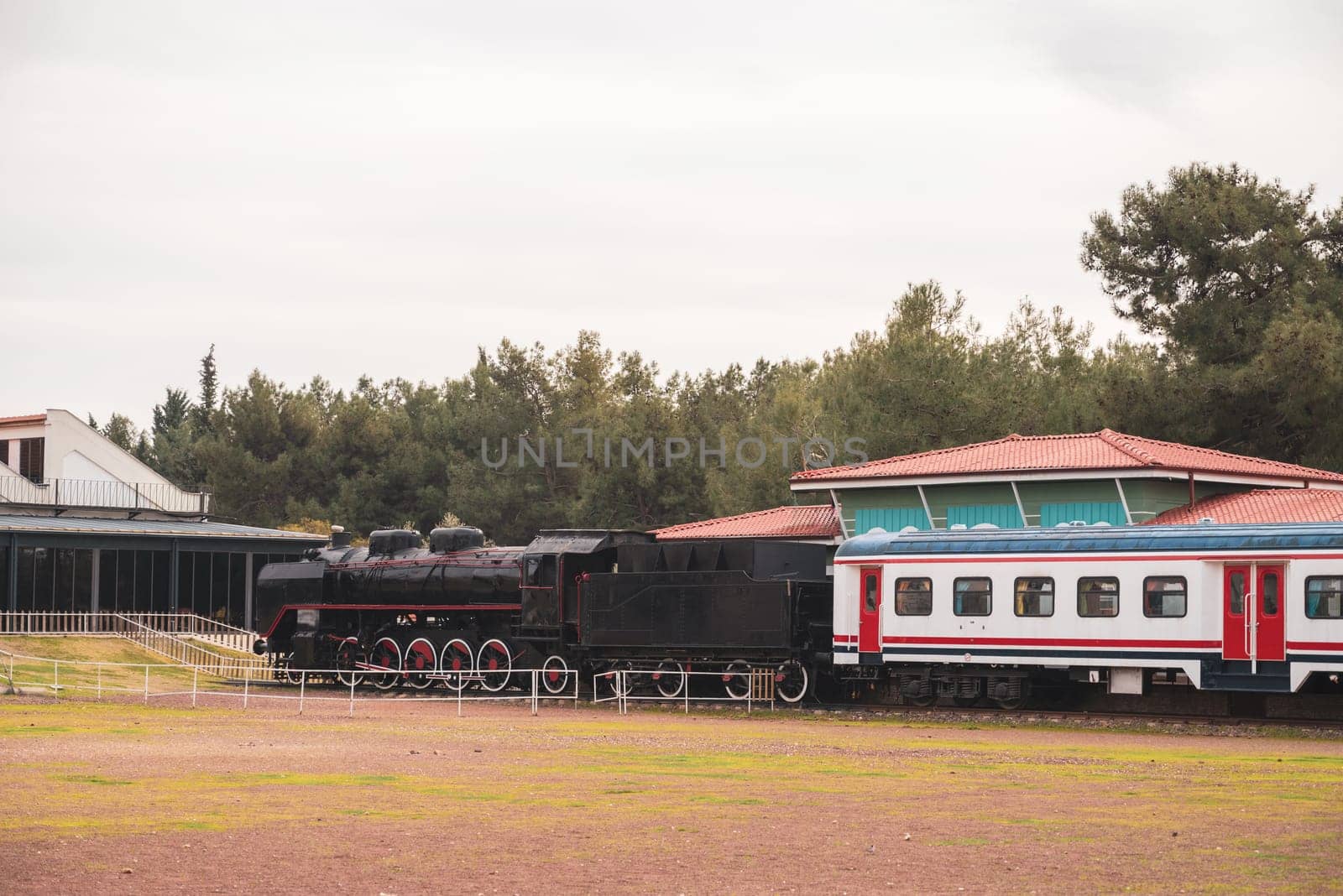 Vintage passenger train waiting for passengers at the train station by Sonat