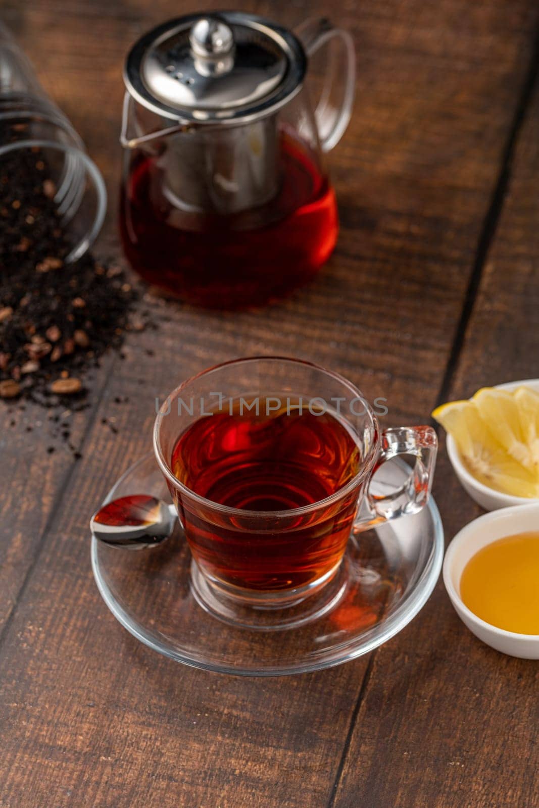Top view of traditional black turkish tea with lemon and honey on wooden background