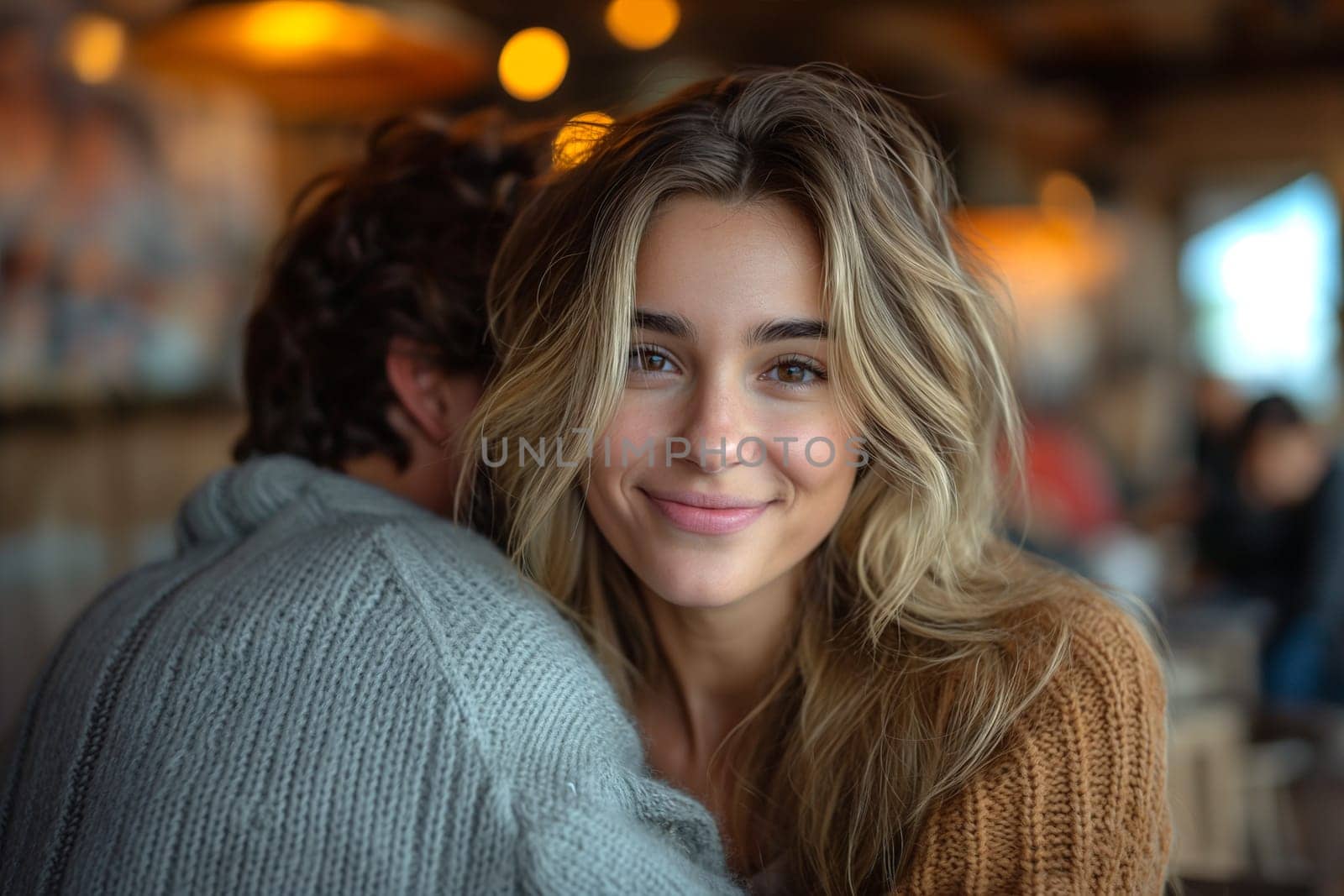 Happy couple hugging in a cafe.