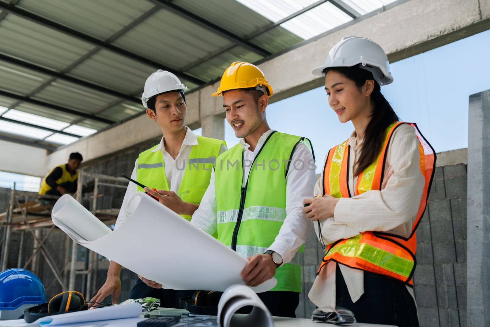 team engineer, foreman, architect meeting for colleagues discussing and checks construction blueprints at onsite by itchaznong