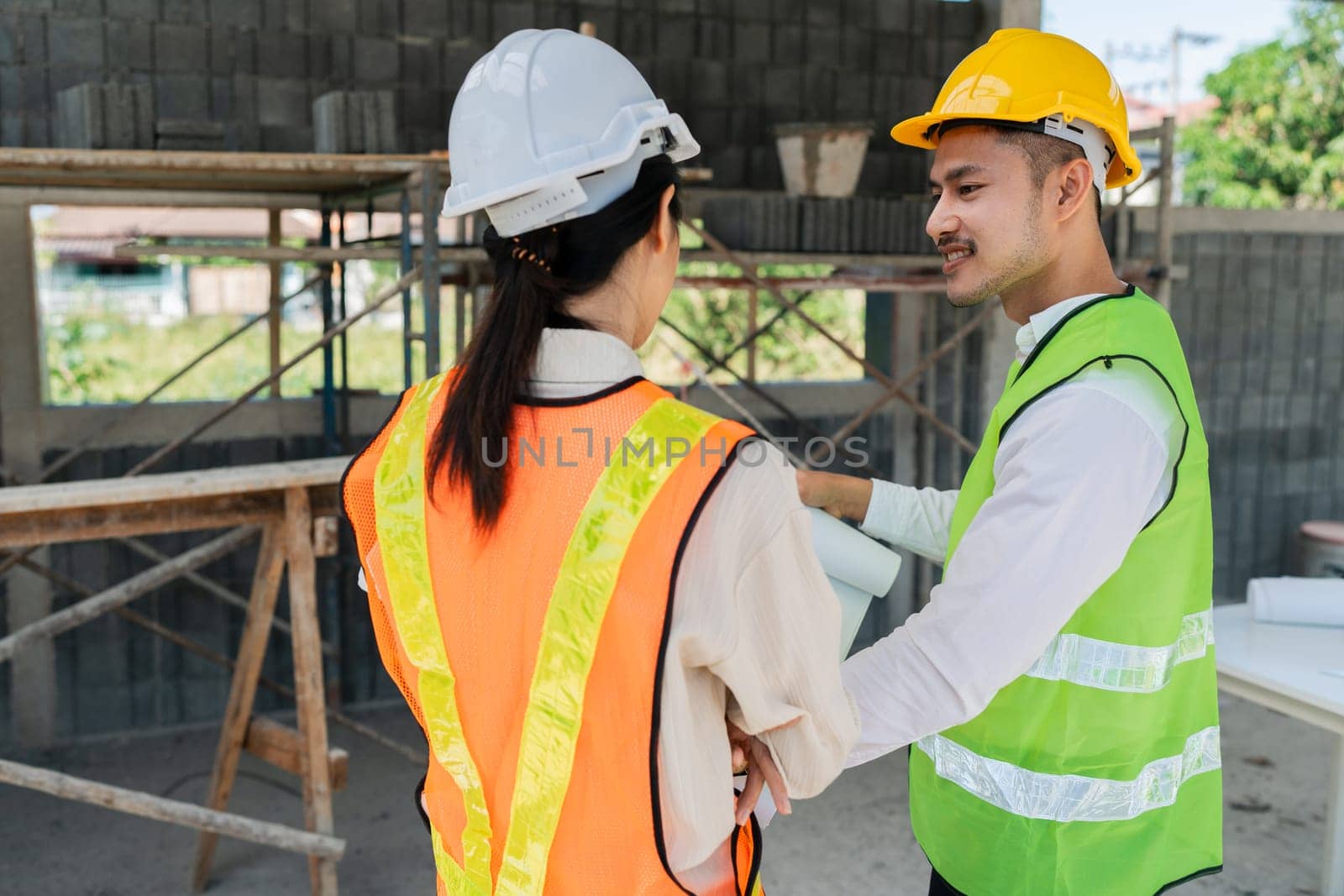 team engineer, foreman, architect meeting for colleagues discussing and checks construction blueprints at onsite by itchaznong