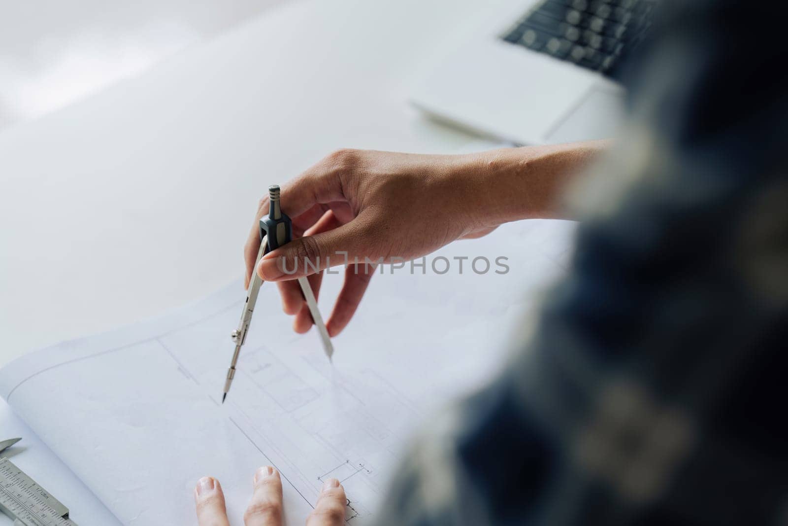 Architect sketching a construction project working on project in modern office.
