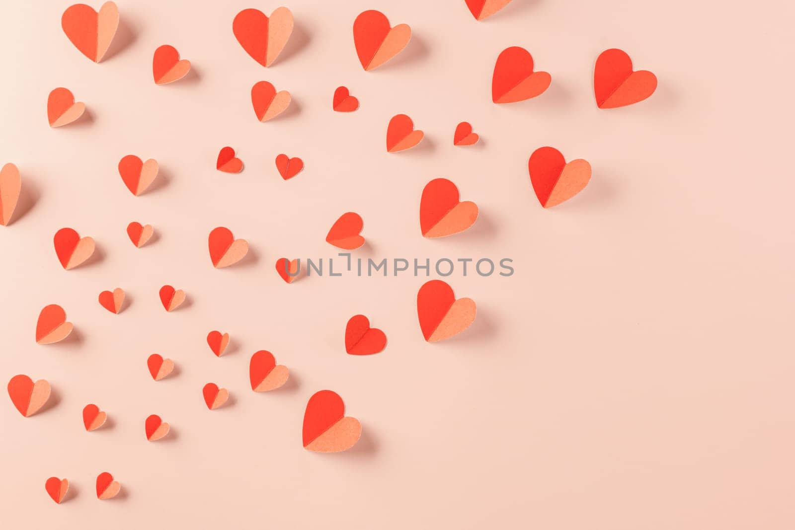 Happy Valentine's day concept. Red paper hearts cutting pastel pink background, Symbol of love paper art with copy space for text, Mother's Day
