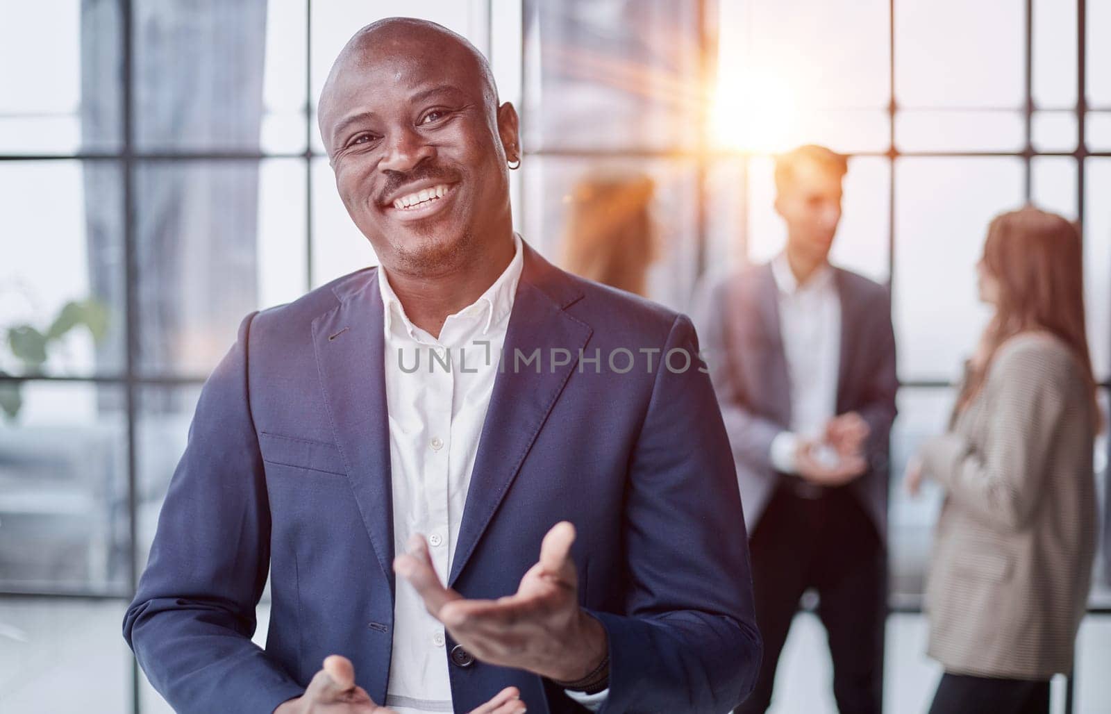 Handsome african american executive businessman in modern office by Prosto