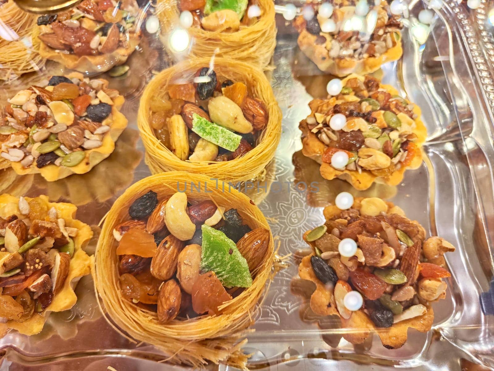 Various types or many colorful assortment of Turkish sweets for sale in shop food festival. Baklava and pastries are sold on trays on the counter. Ramadan, travel