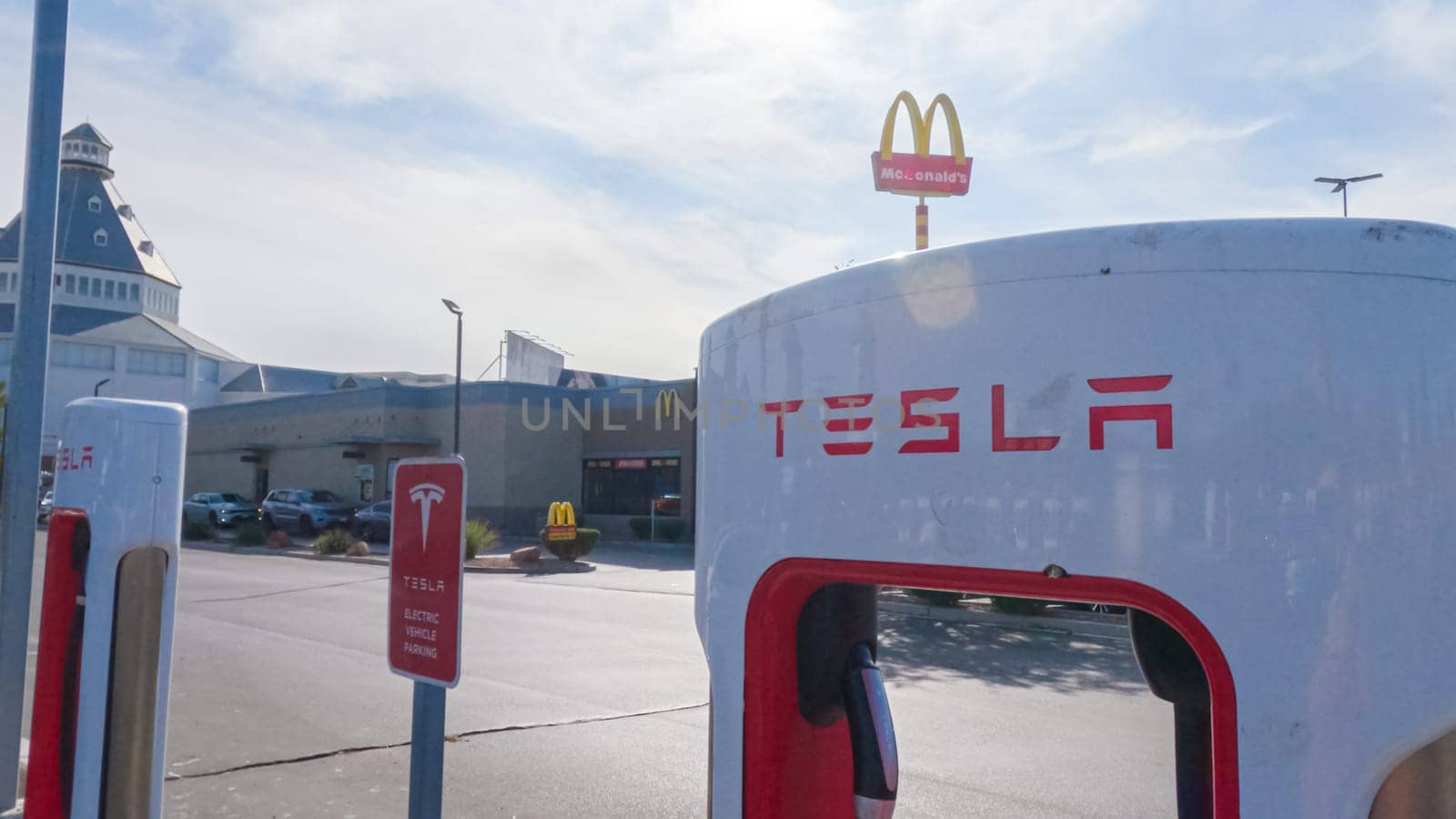 Daytime Tesla Charging: Supercharging Station Power-Up by arinahabich