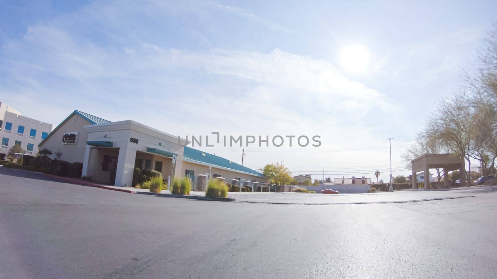 Driving through a bustling Las Vegas residential neighborhood during the day reveals the vibrant energy and unique architectural styles that make the city's communities so captivating.