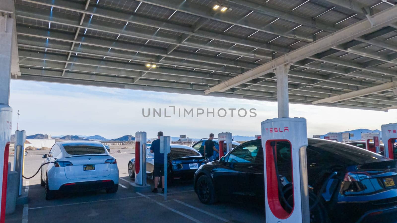 Daytime Tesla Charging, Supercharging Station Power-Up by arinahabich