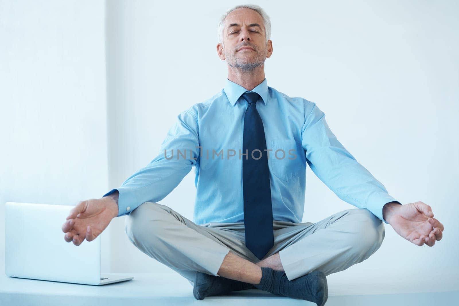 Businessman, meditation and hands for calm wellness for work stress relief or corporate, professional or mental health. Male person, lawyer and legs crossed for zen practice, mindfulness or peace by YuriArcurs