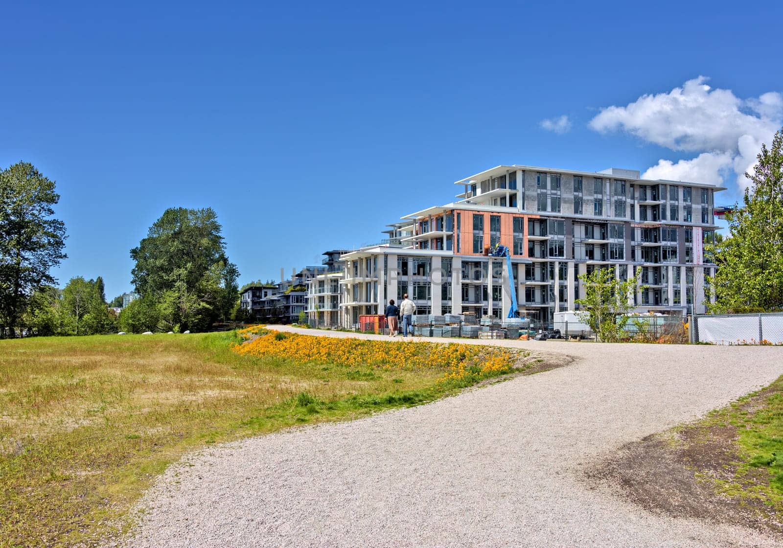 Z shaped pathway in front of new residetial buildings under construction on blue sky background