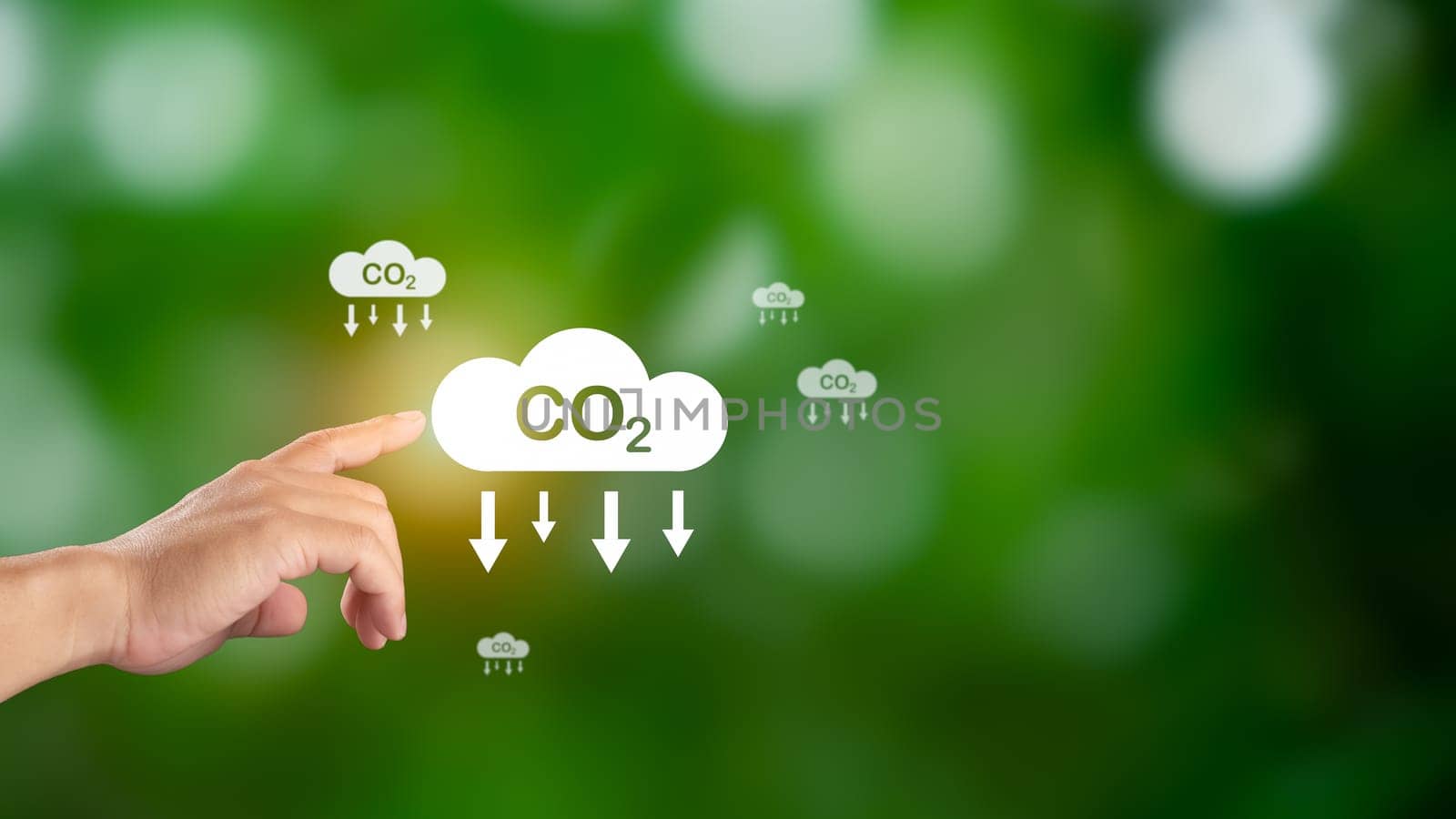 Hand holding CO2 reducing icon for decrease carbon dioxide emission, Business and environment sustainable, industry and company Reduce of carbon emissions to Net zero greenhouse gas target.