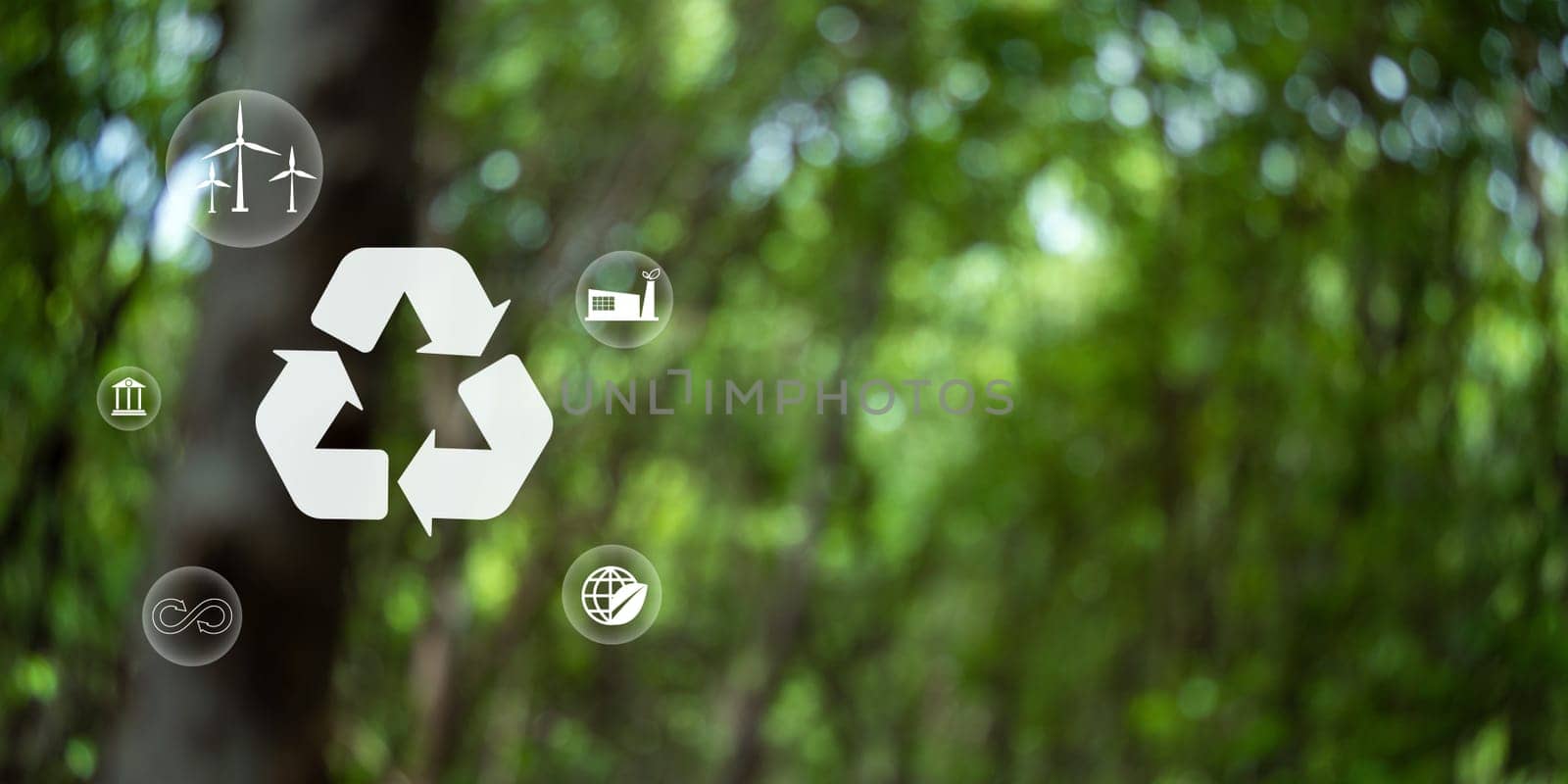 Recycle symbol on green bokeh background. Ecological and save the earth concept. An ecological metaphor for ecological waste management and a sustainable. by Unimages2527