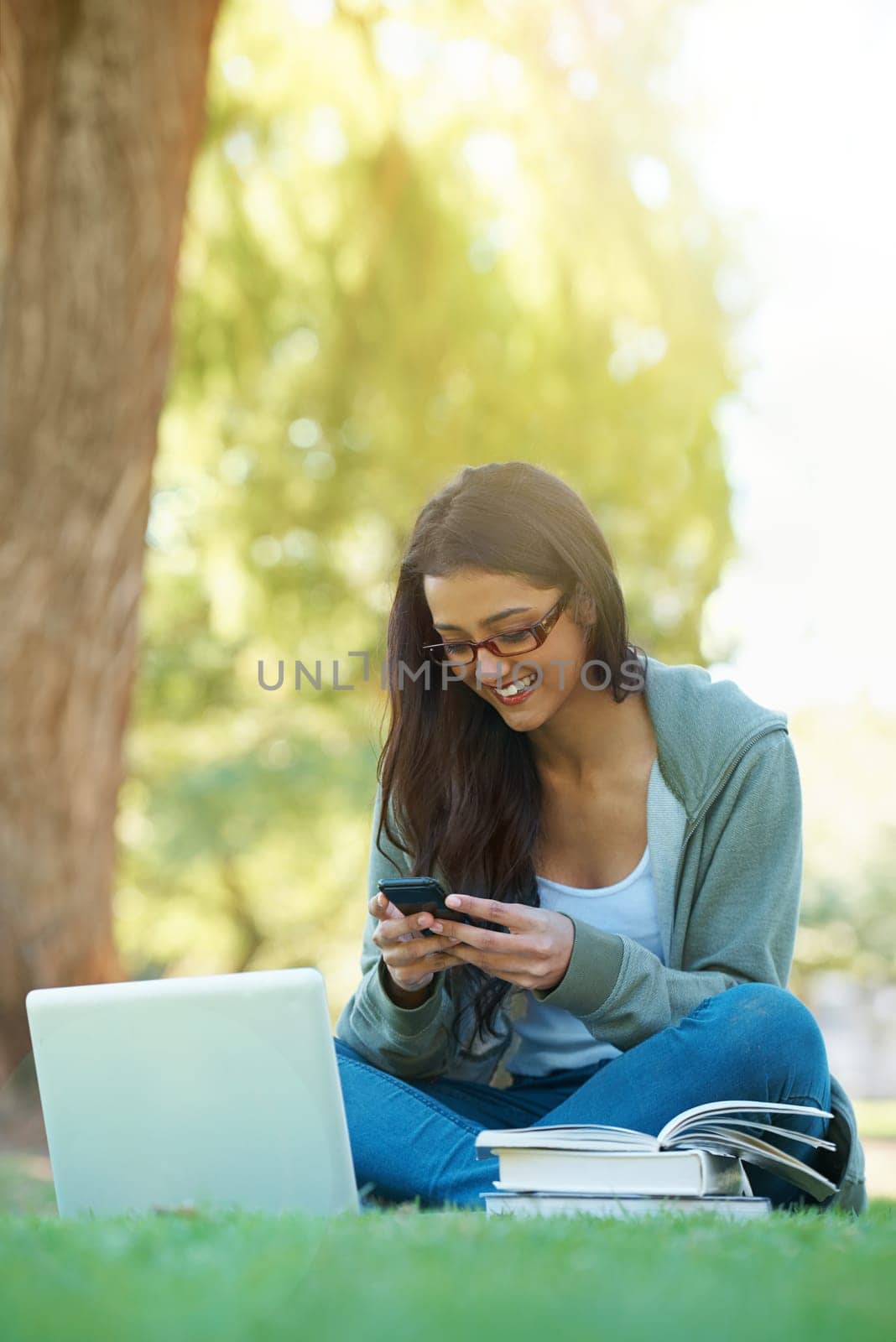 Woman, garden and laptop with books, glasses and cellphone for study, learning and college. Latino student, park and technology for research, communication and university for online education.