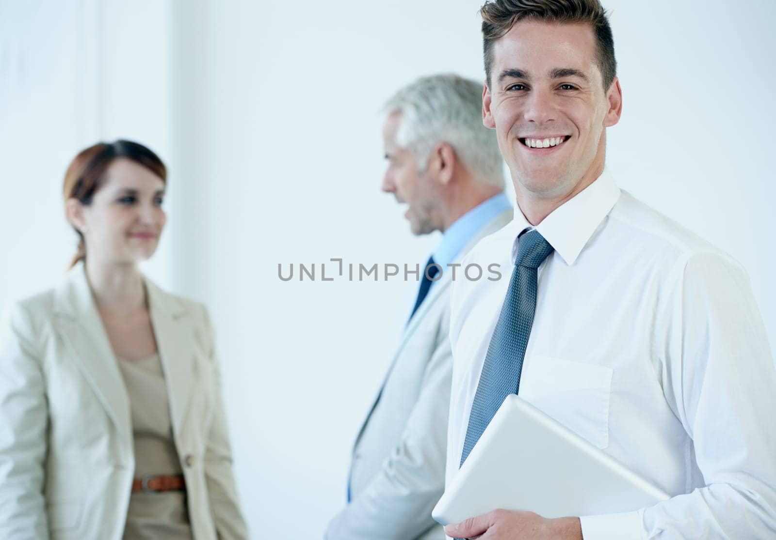 Businessman, portrait and confidence in office, company pride and smiling with tablet for leadership. Business people, communication and discussion in workplace, support and teamwork on technology.