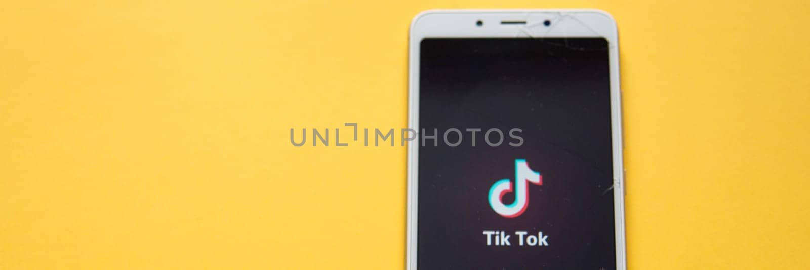 Tver, Russia - February 12, 2020 Tik tok logo on smartphone screen on green background. Tik Tok icon. tik tok application. Tiktok Social media network. by Annu1tochka