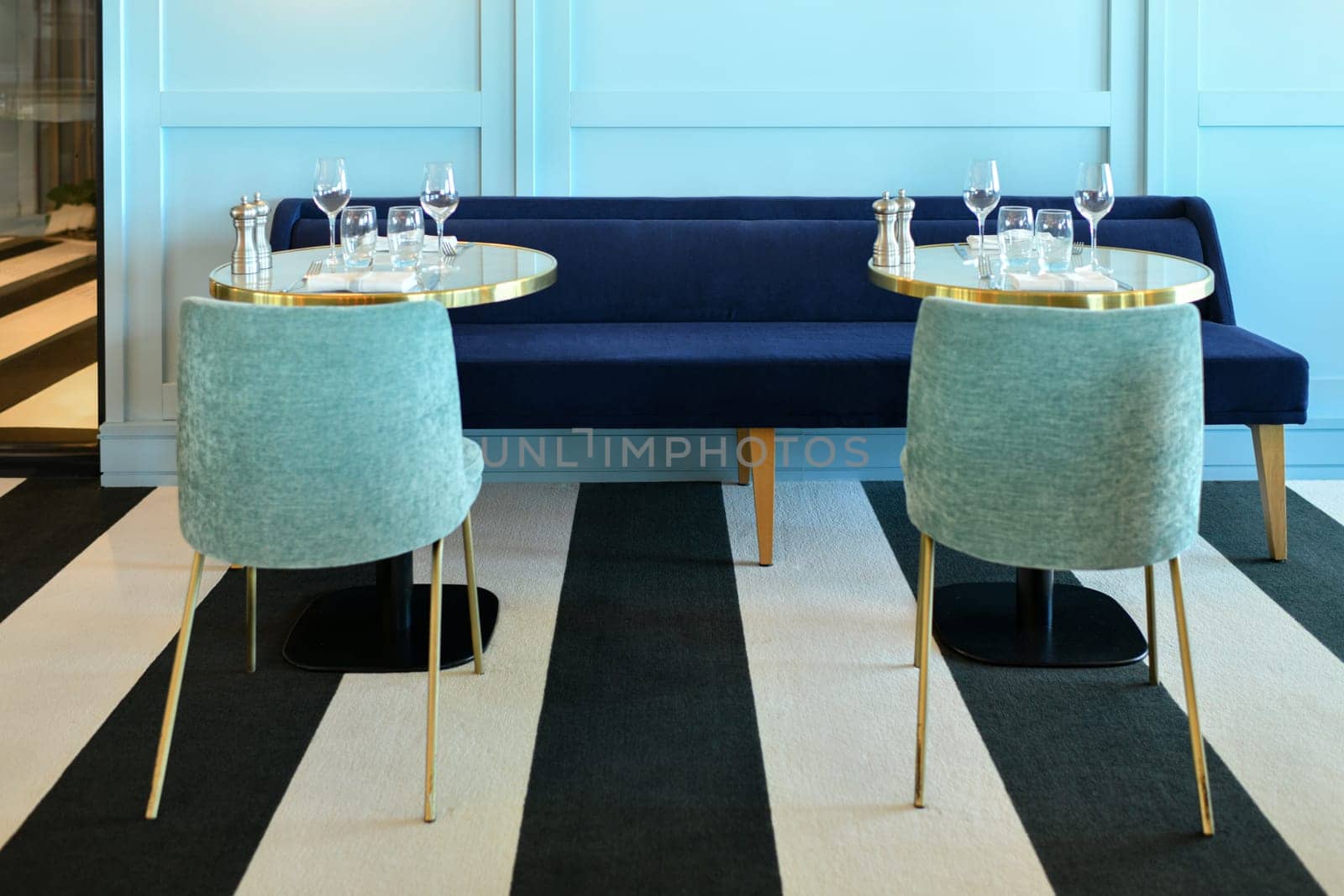 Served tables in a modern blue restaurant interior