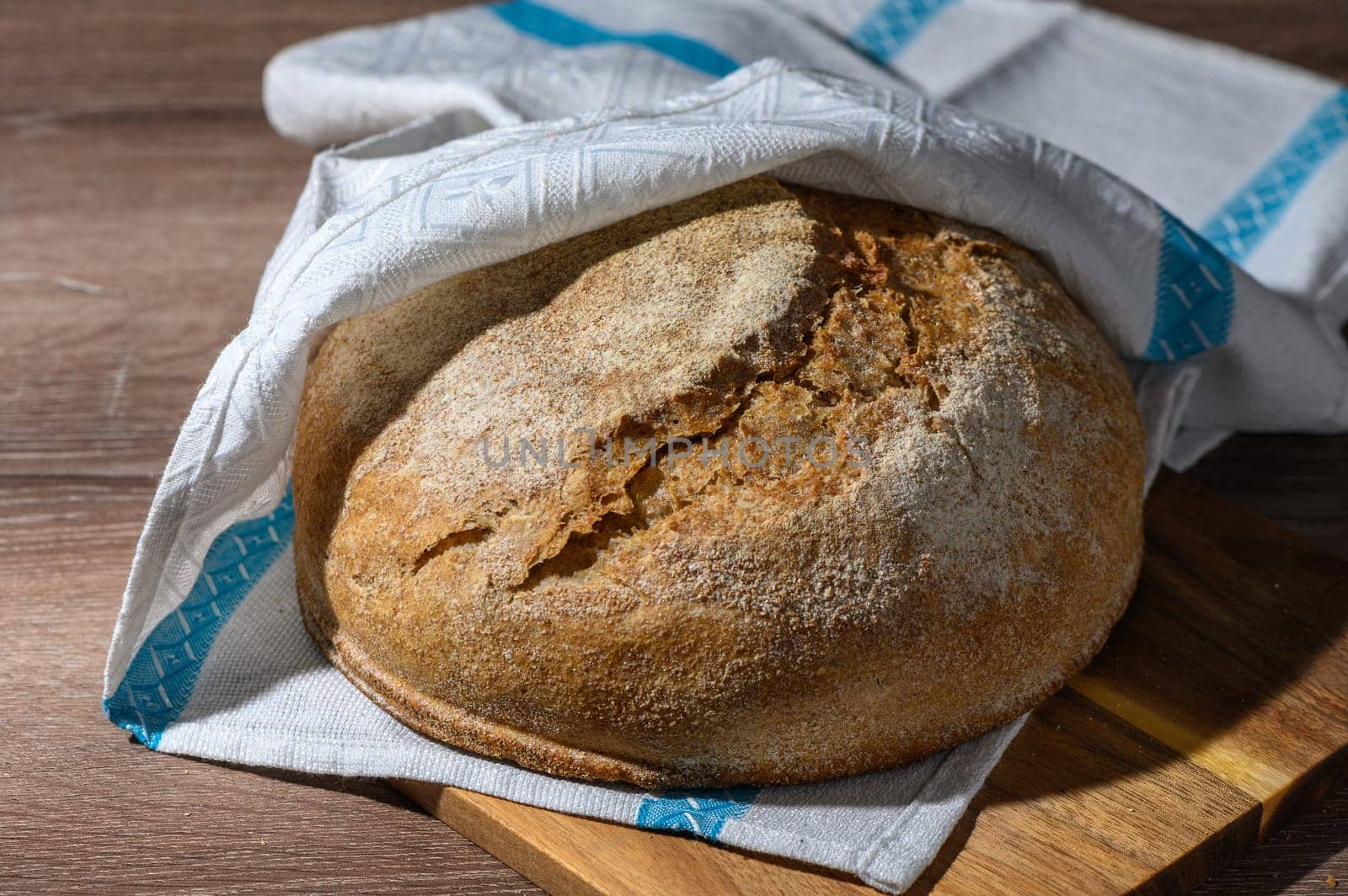 homemade whole grain bread in the kitchen on a wooden table 4