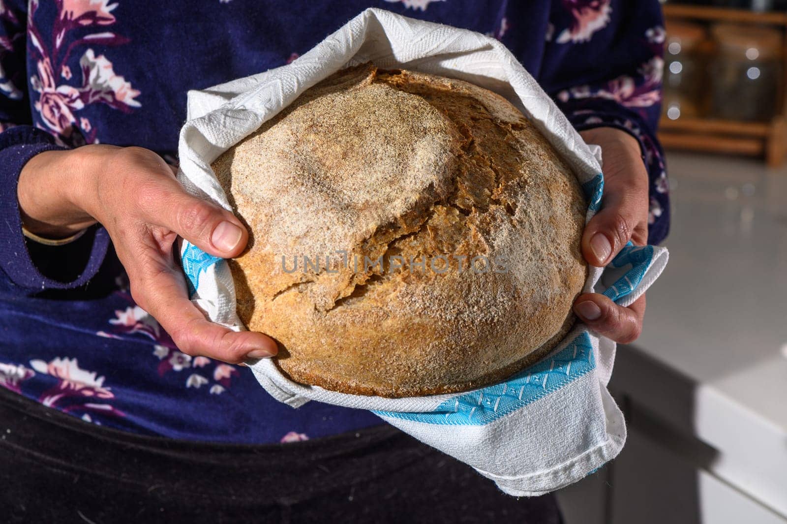 Woman holding homemade whole grain bread in her hands 6