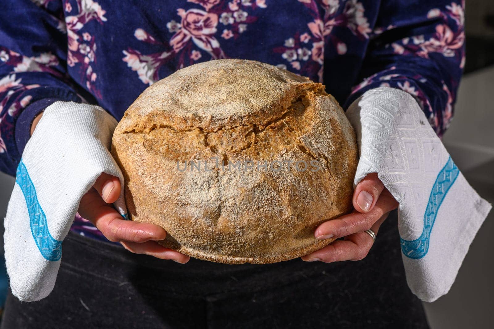 Woman holding homemade whole grain bread in her hands 4
