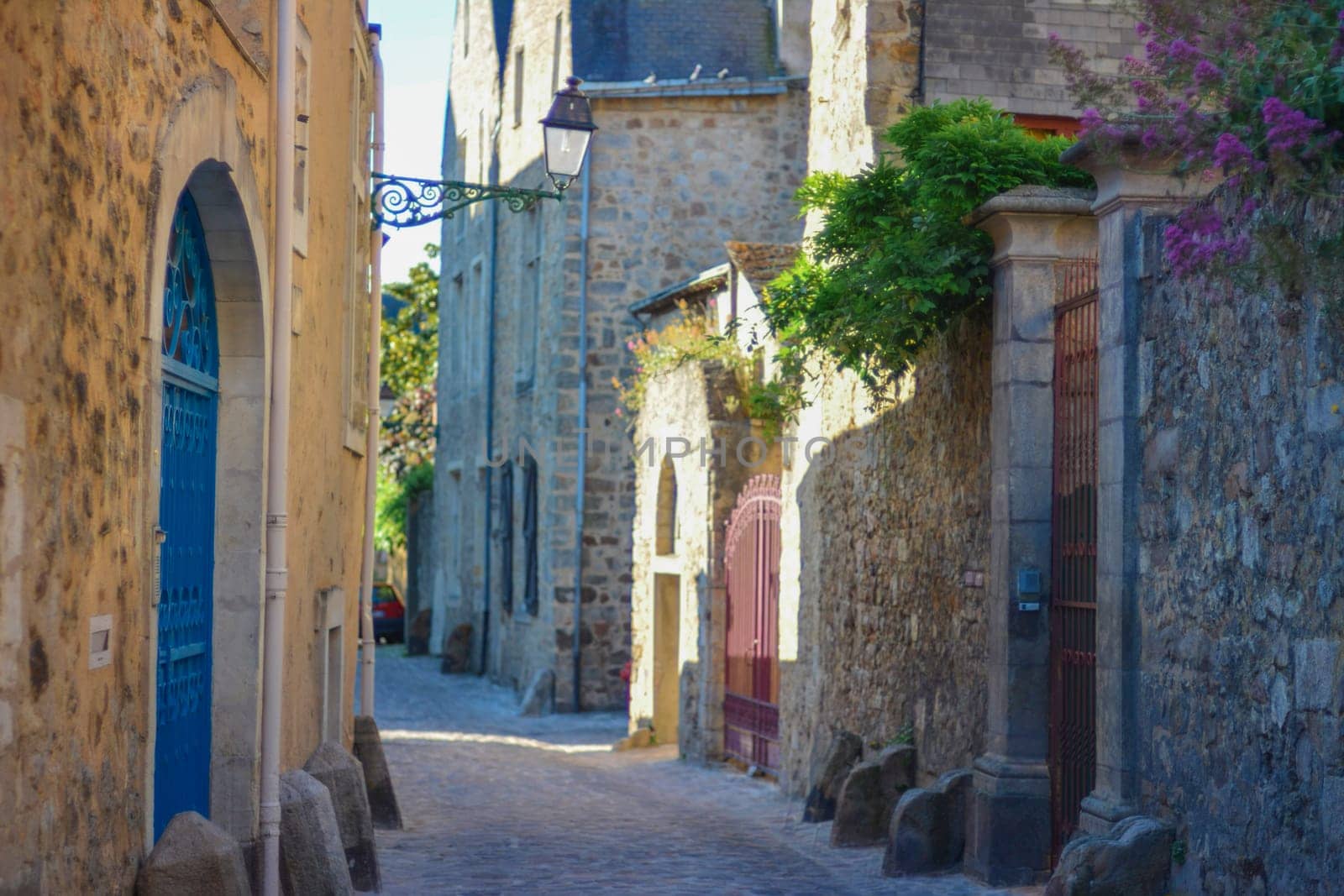 Narrow streets from paving stones with medieval stones for coachmen at a Le mans, France