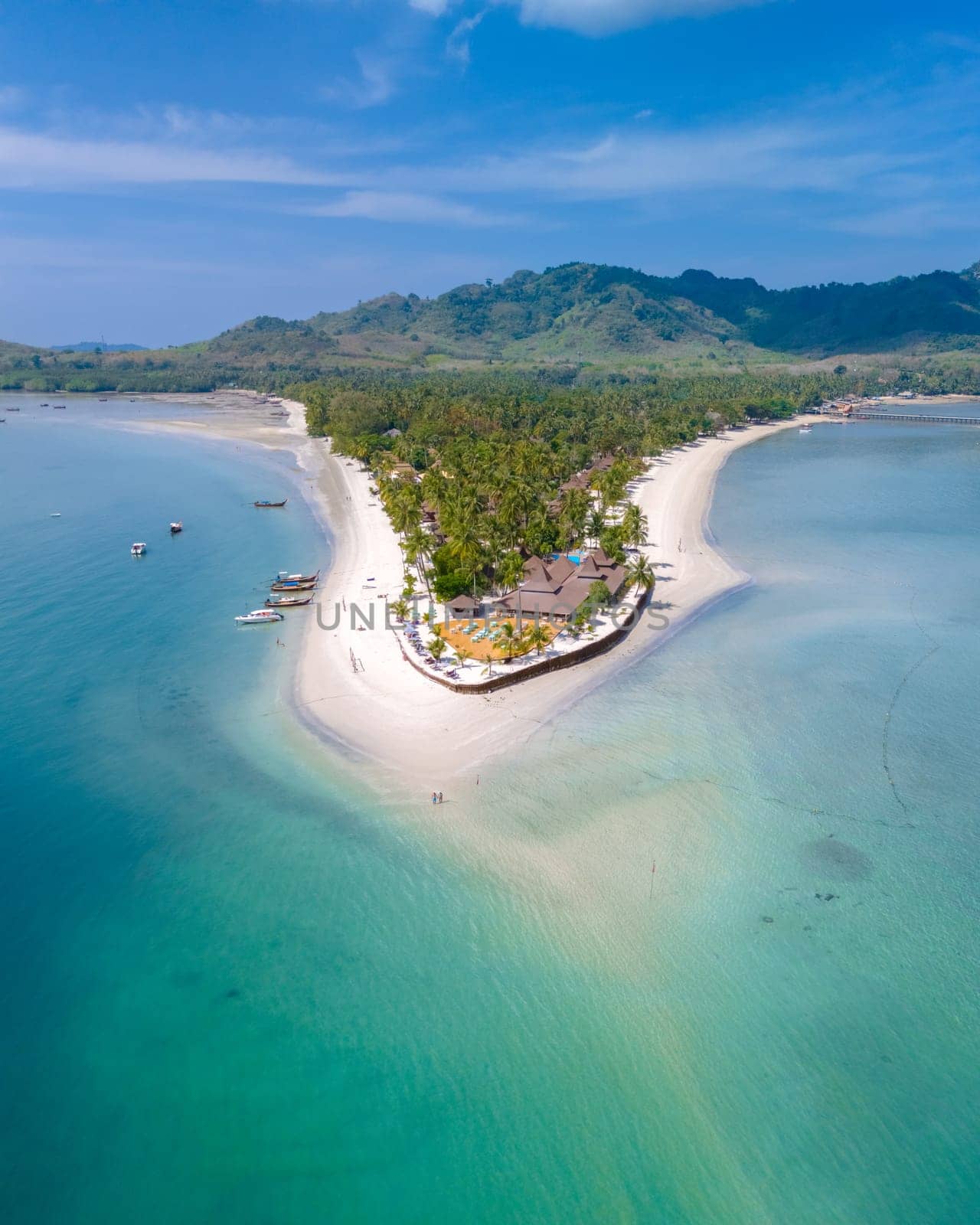 Drone aerial view at Koh Muk a tropical island in Trang Thailand, palm trees and soft white sand, and a turqouse colored ocean in Koh Mook Trang Thailand