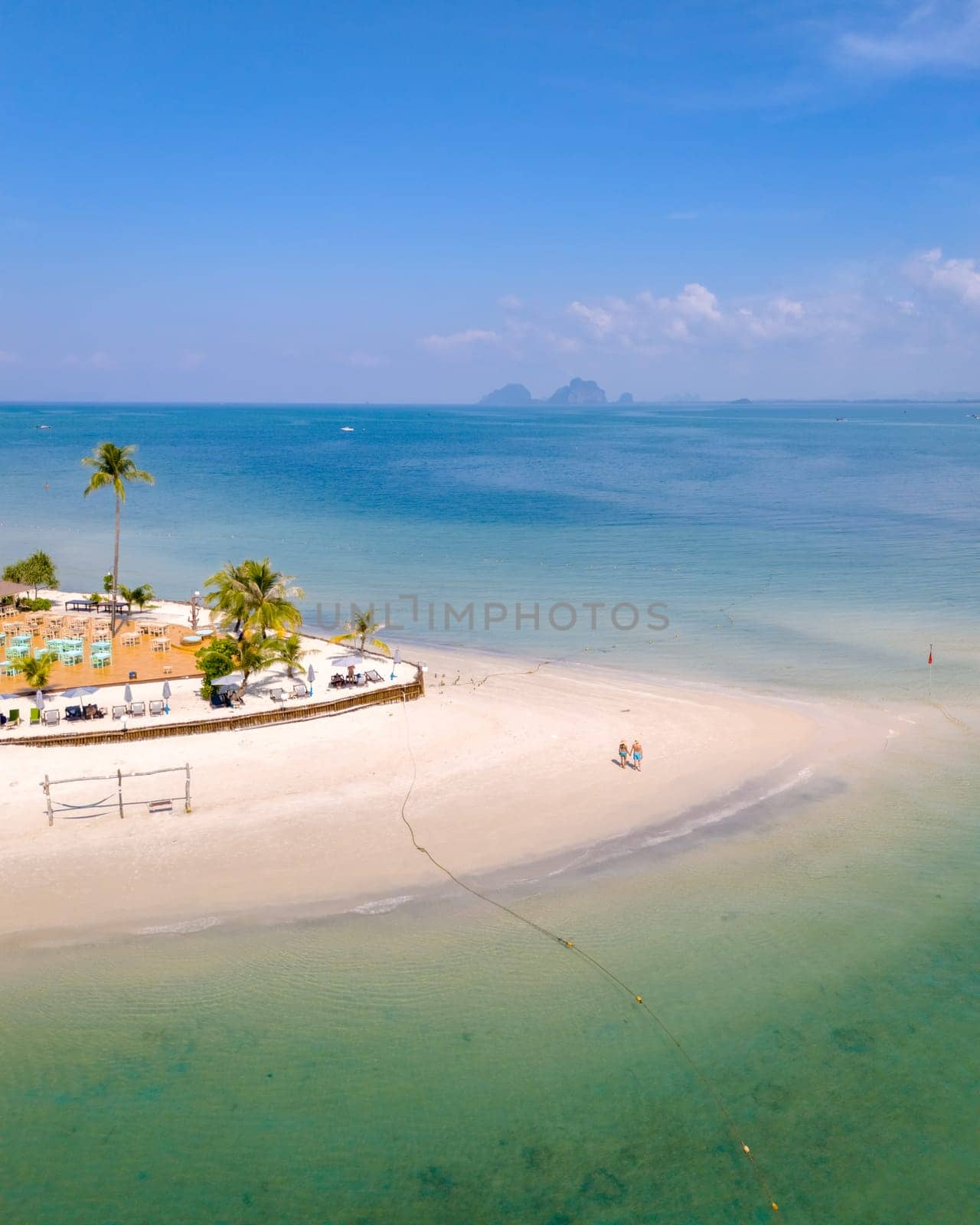 Drone aerial view at Koh Muk a tropical island in Trang Thailand, palm trees and soft white sand, and a turqouse colored ocean in Koh Mook Trang Thailand