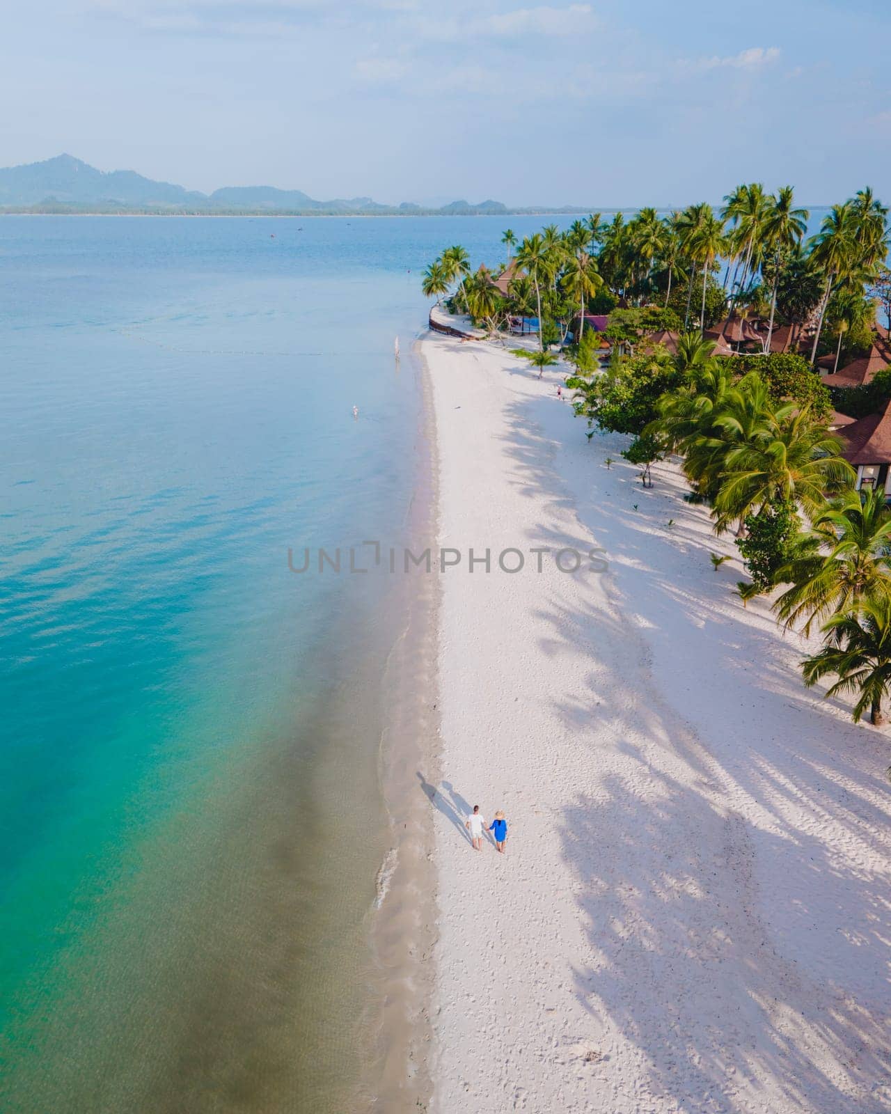 Koh Mook Drone view at a couple walking on the white sandy tropical beach of Koh MukThailand by fokkebok