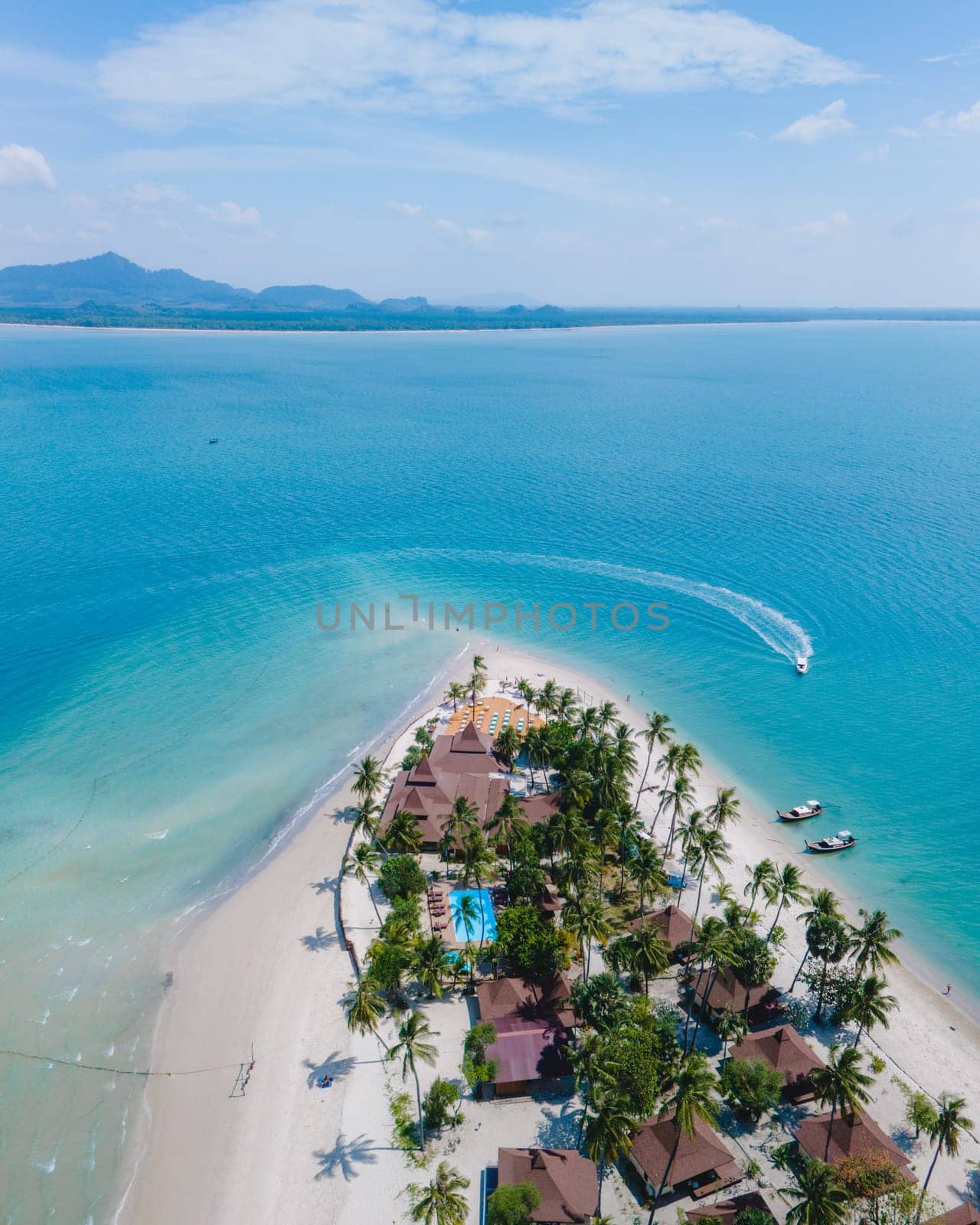 top view at Koh Muk a tropical island with palm trees and soft white sand, and a turqouse colored ocean, Koh Mook Island Trang Thailand