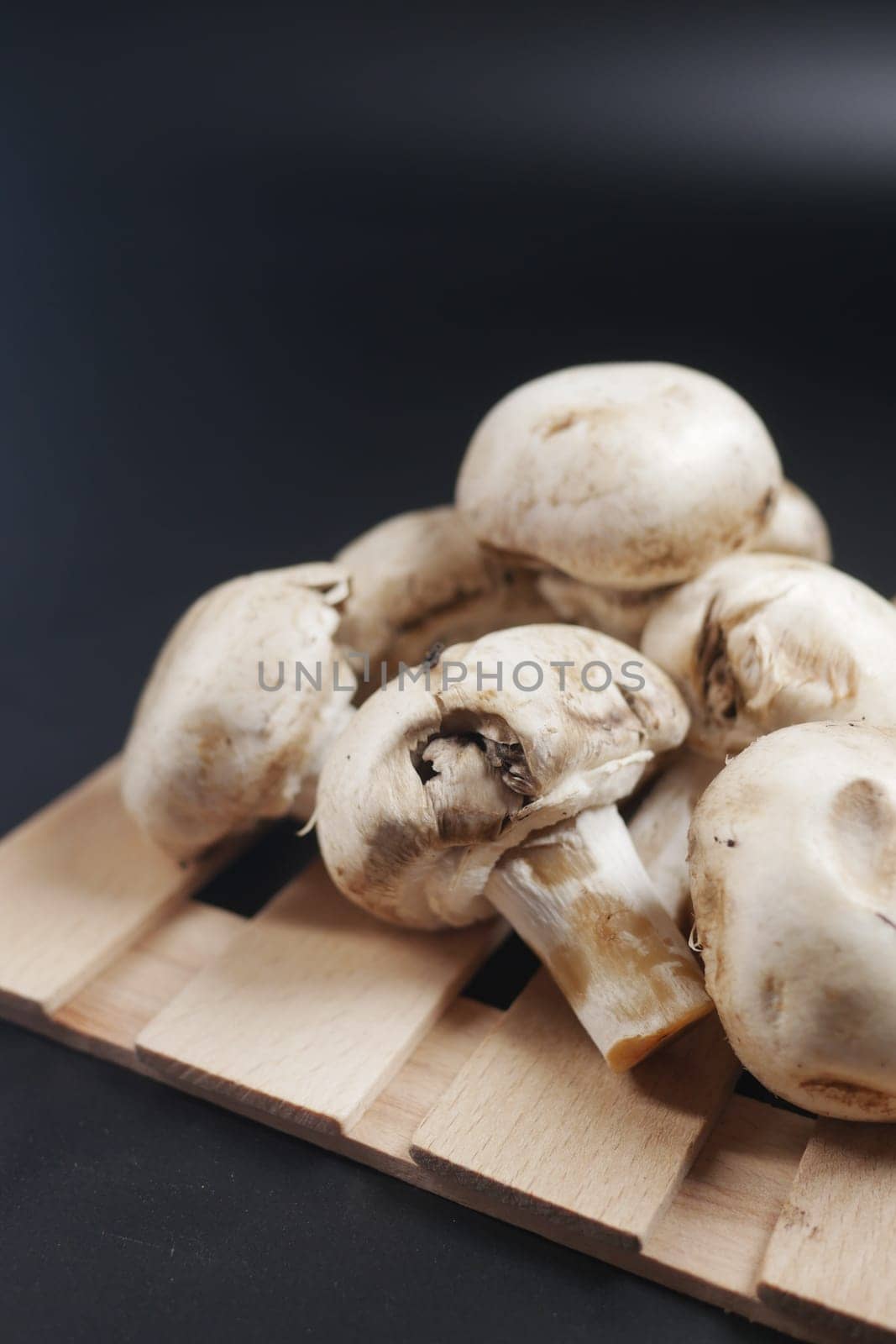 Fresh champignons mushroom on black background by towfiq007