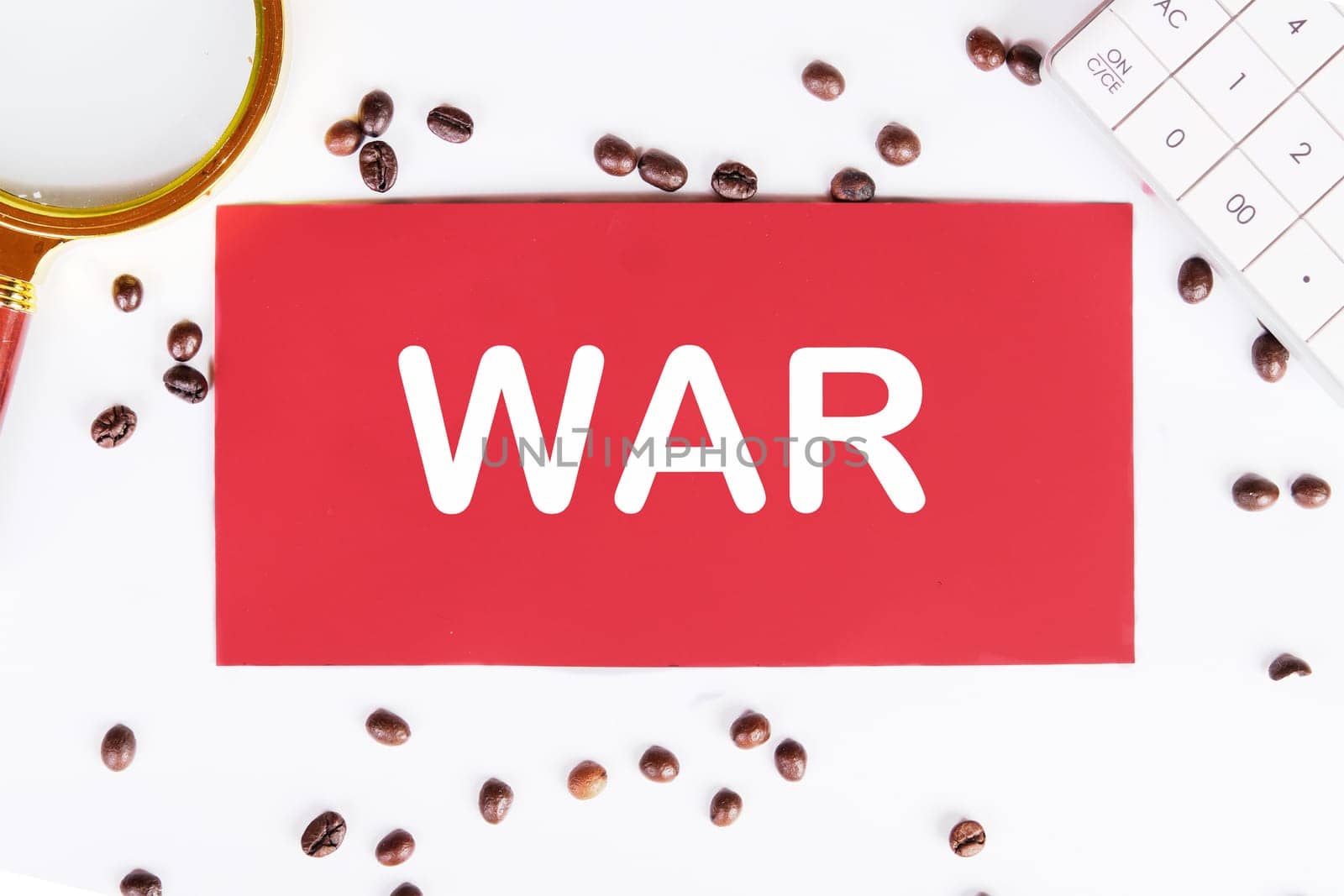 WAR writing on a red card on a white background with coffee beans and a magnifying glass